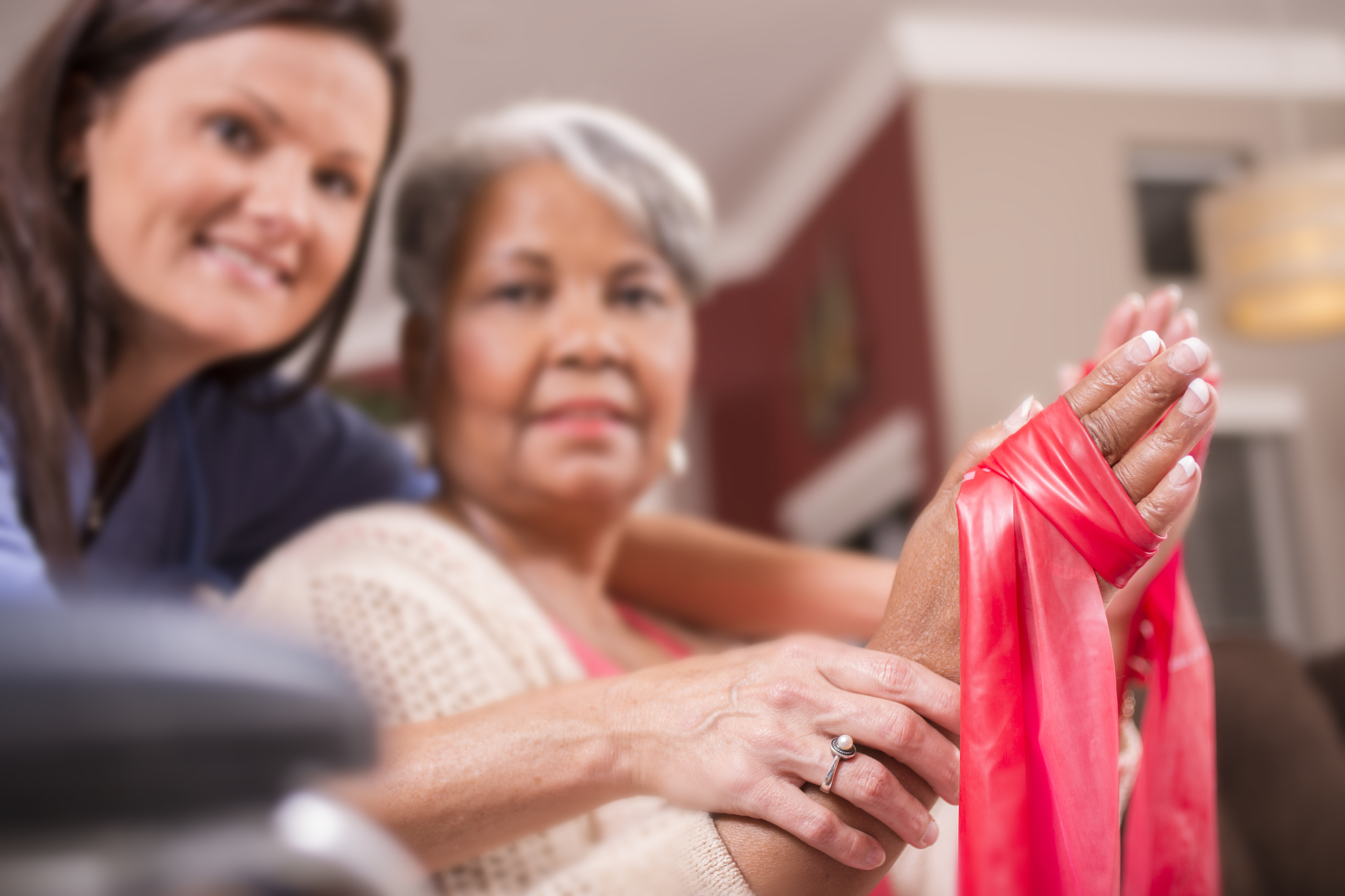 home healthcare nurse, physical therapy with senior adult woman.