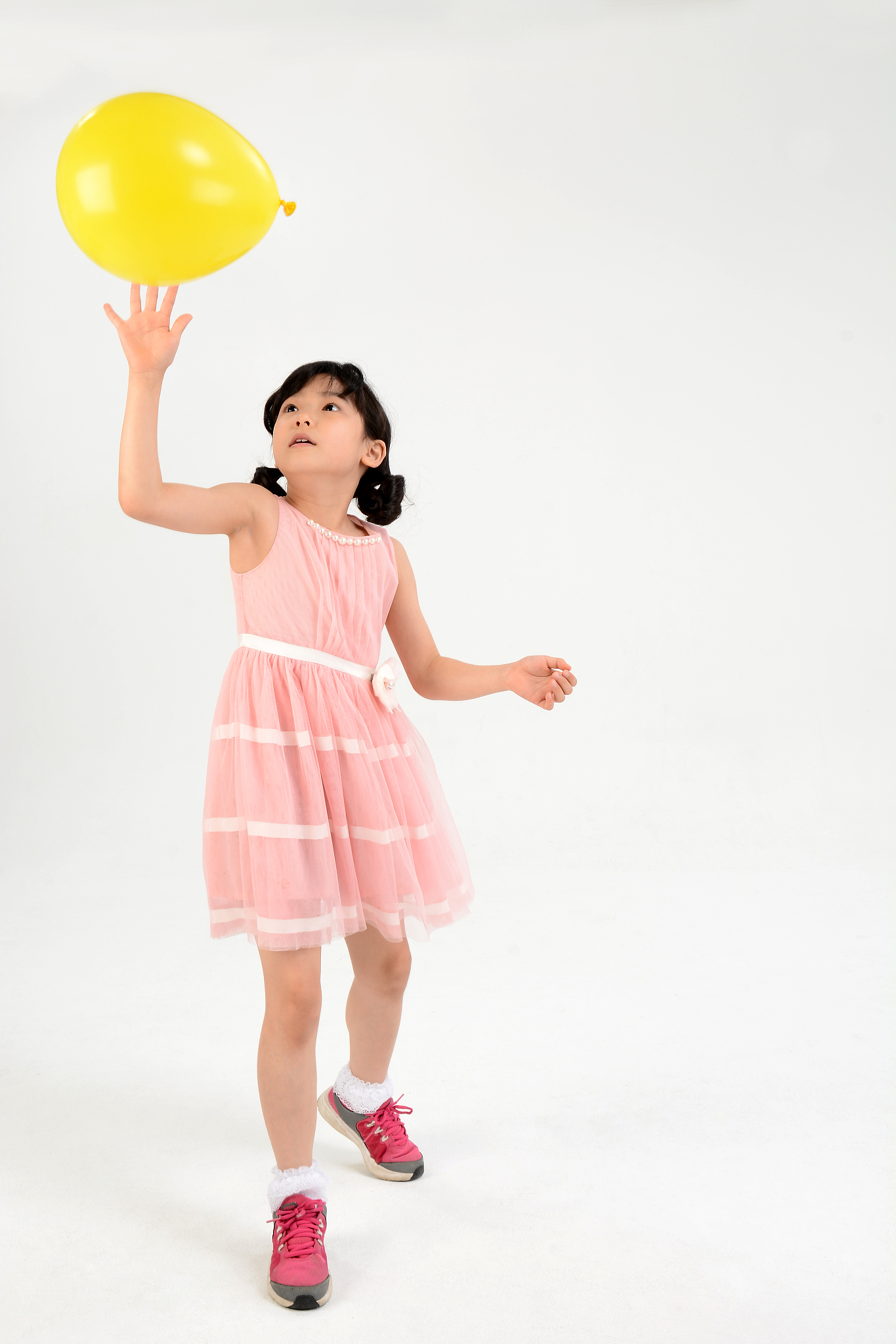 girl playing with balloons