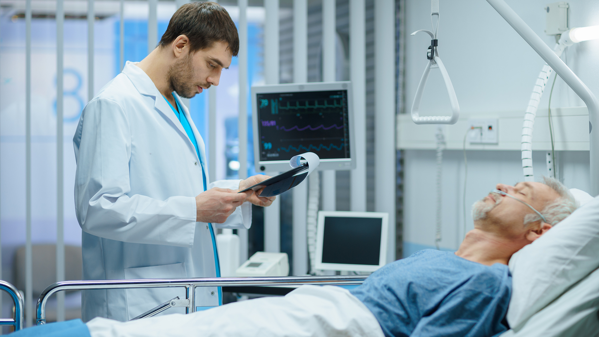 in the hospital sick man rests, lying on the bed, doctor check u