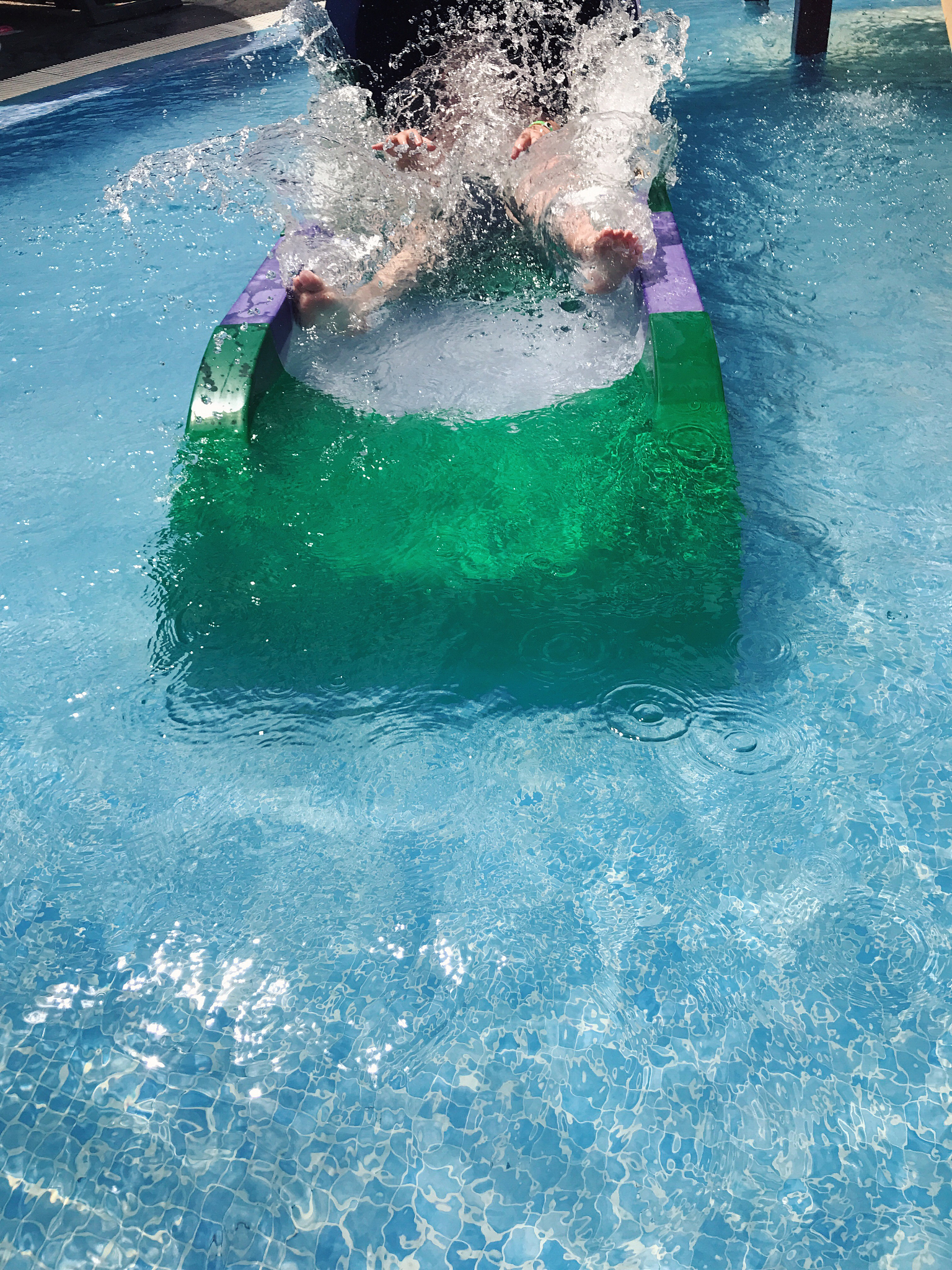 child playing on a water slide