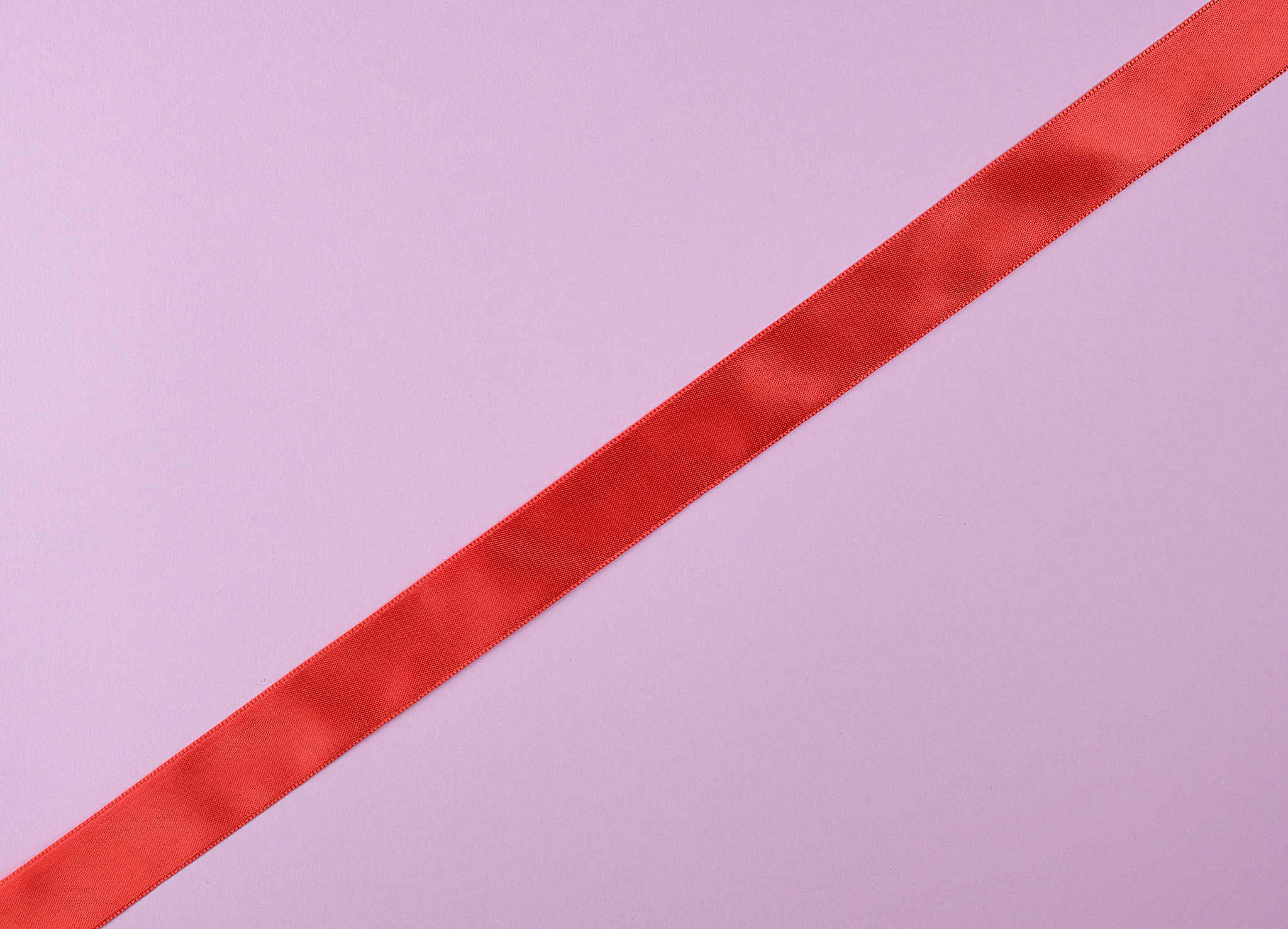 red satin ribbon on a purple  background