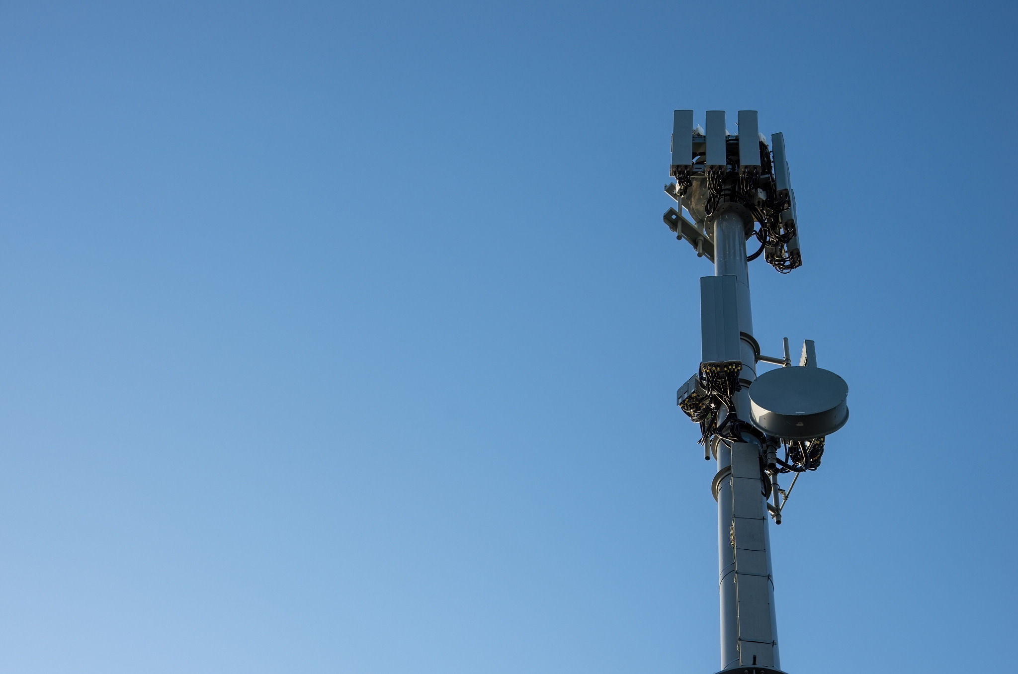 mobile phone repeater tower against a clear blue sky