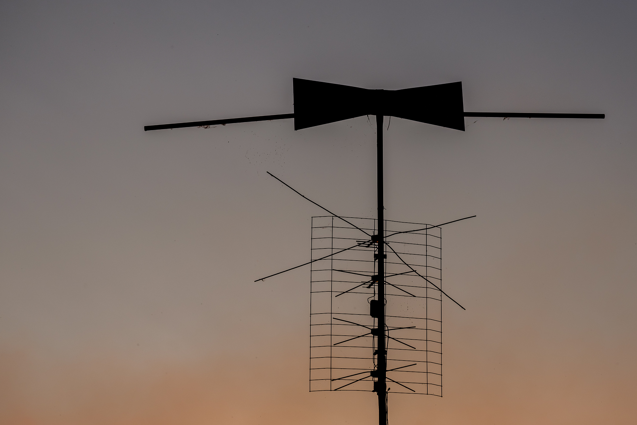 old home made antenna with cobwebs and dirt