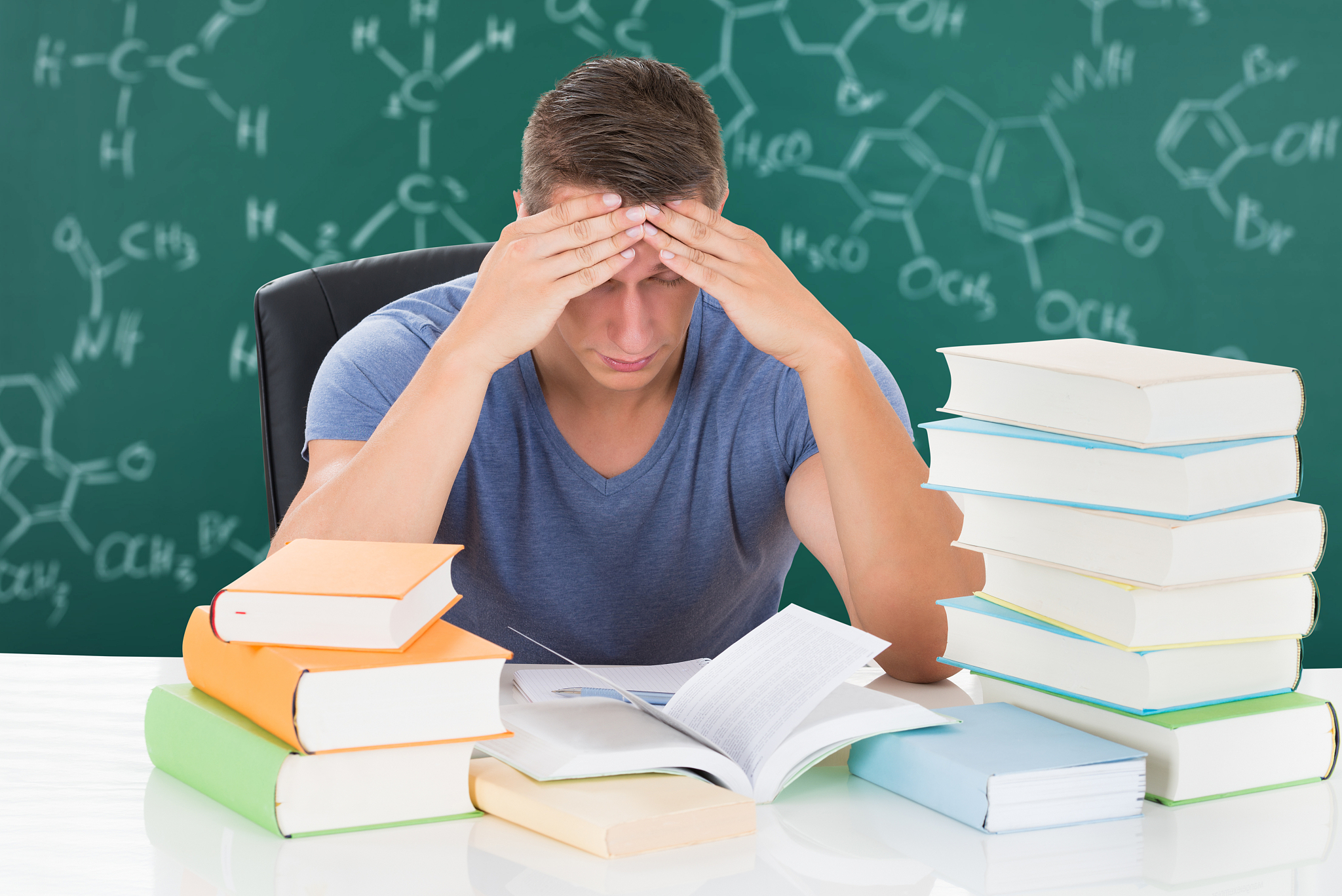tired man studying books