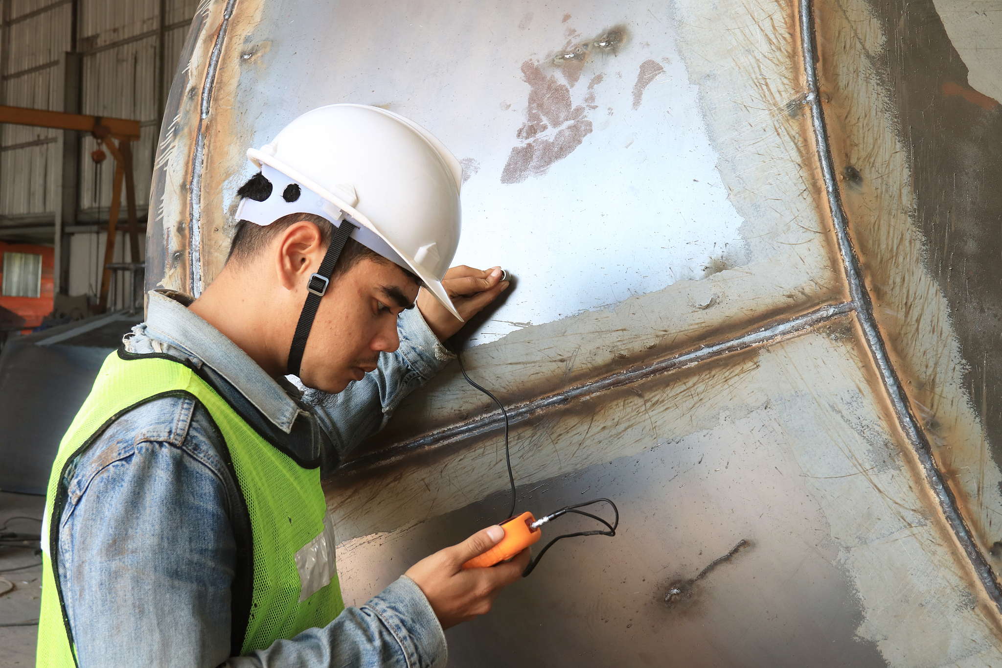 mechanic engineer in factory checking quality of metals