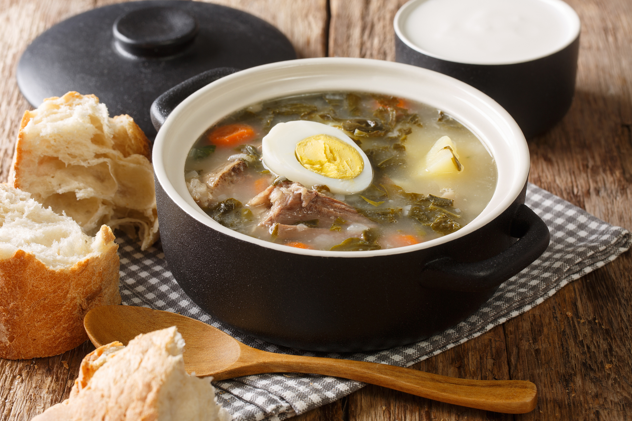 portion of green borsch from sorrel, vegetables, eggs with meat 