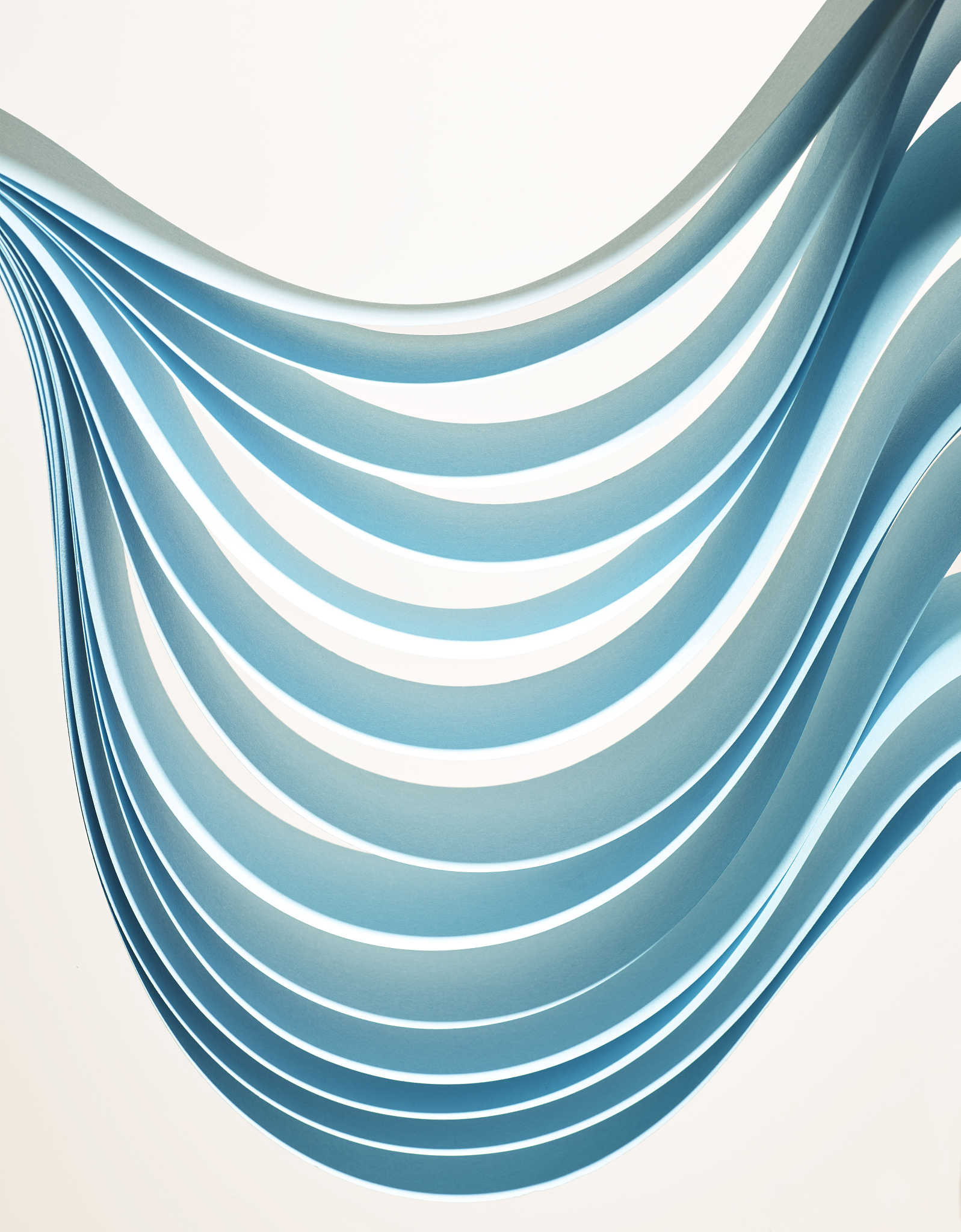 abstract curves of paper against a white background