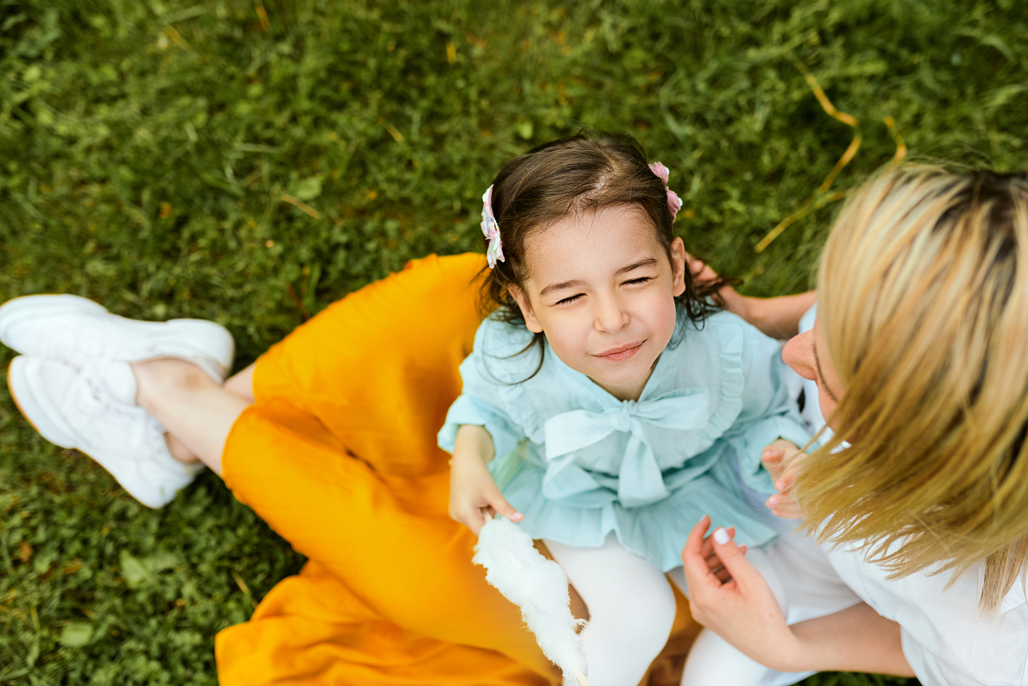 view from above of happy child playing with her mother, enjoying