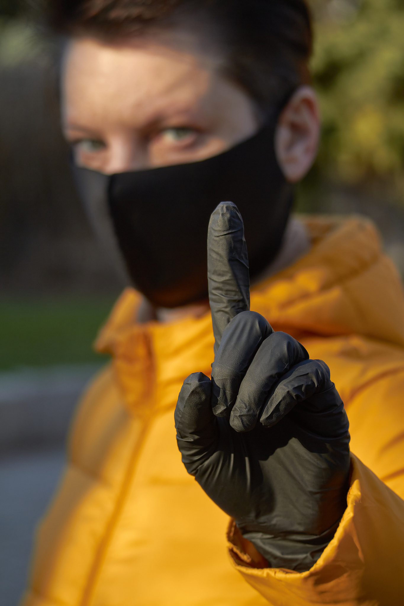middle aged european woman in protective black mask makes an war