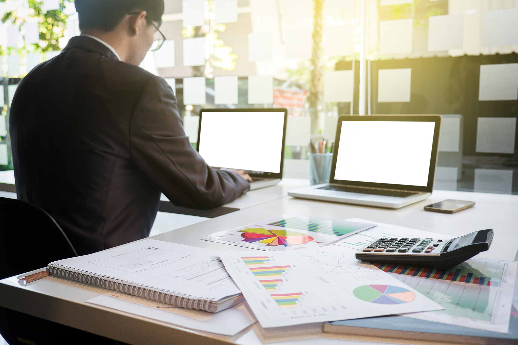 image of young businessmen using laptop with many document graph