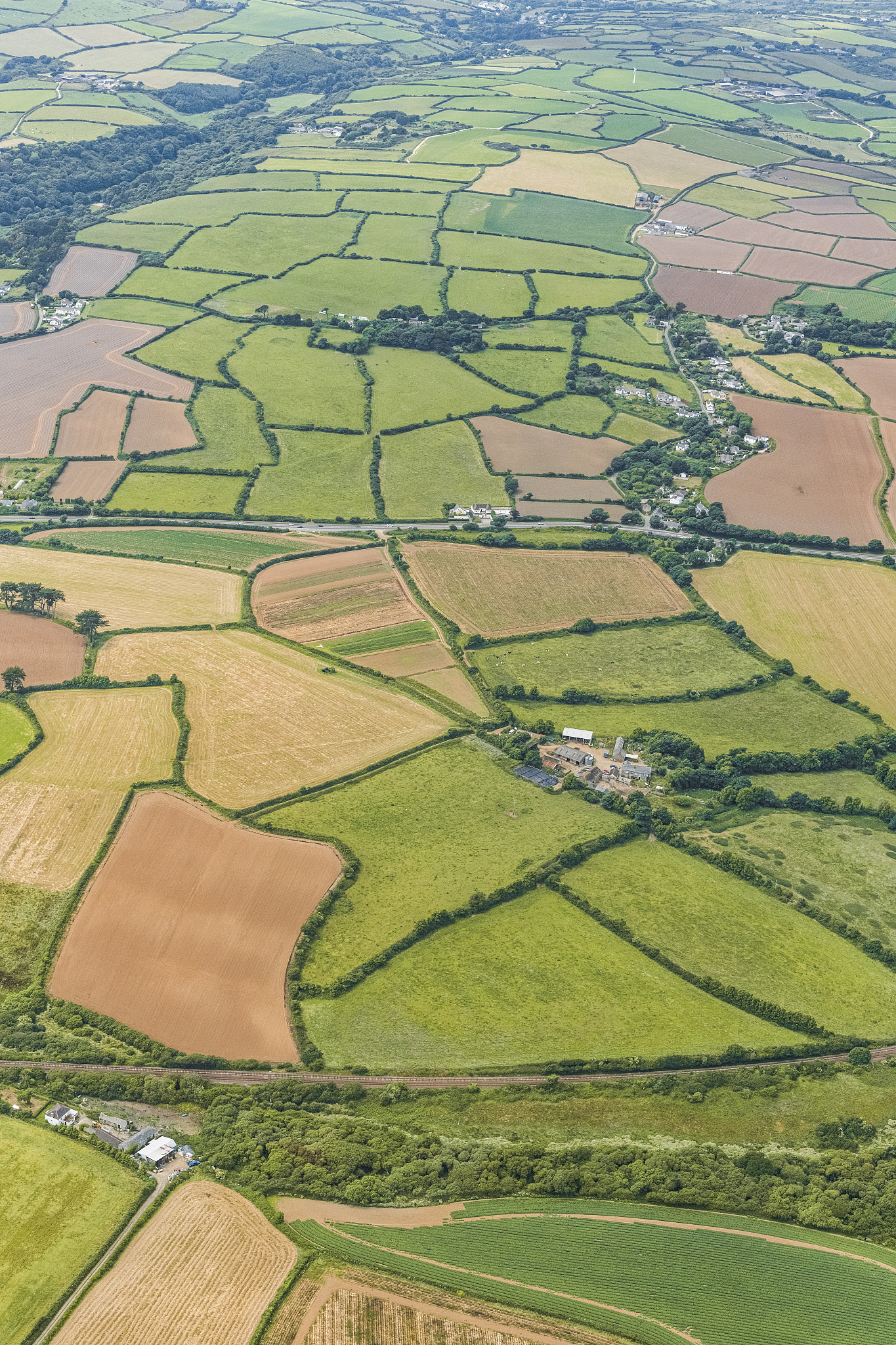 aerial views over west cornwall countryside on a sunny june day.