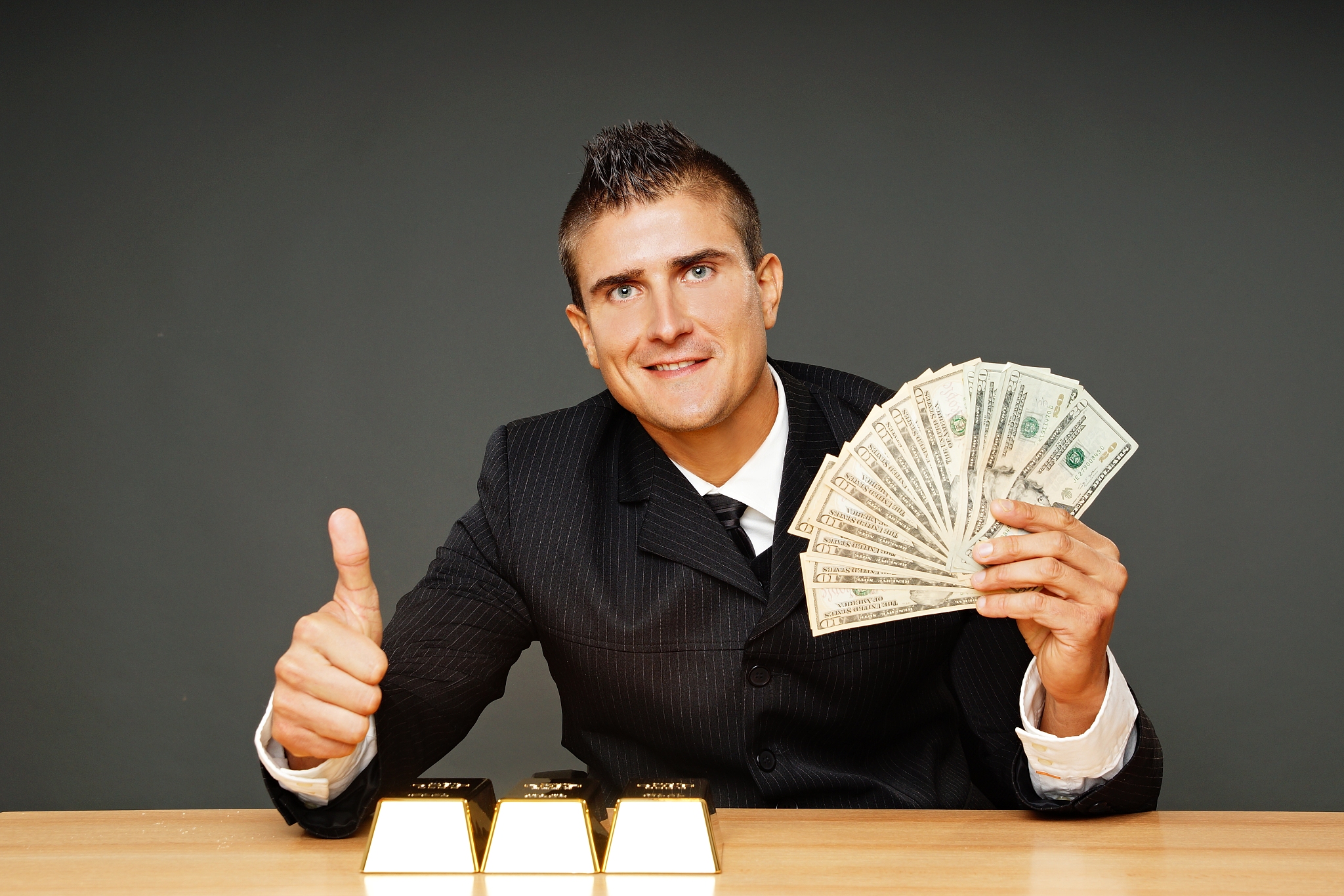 businessman shows money and thumb up