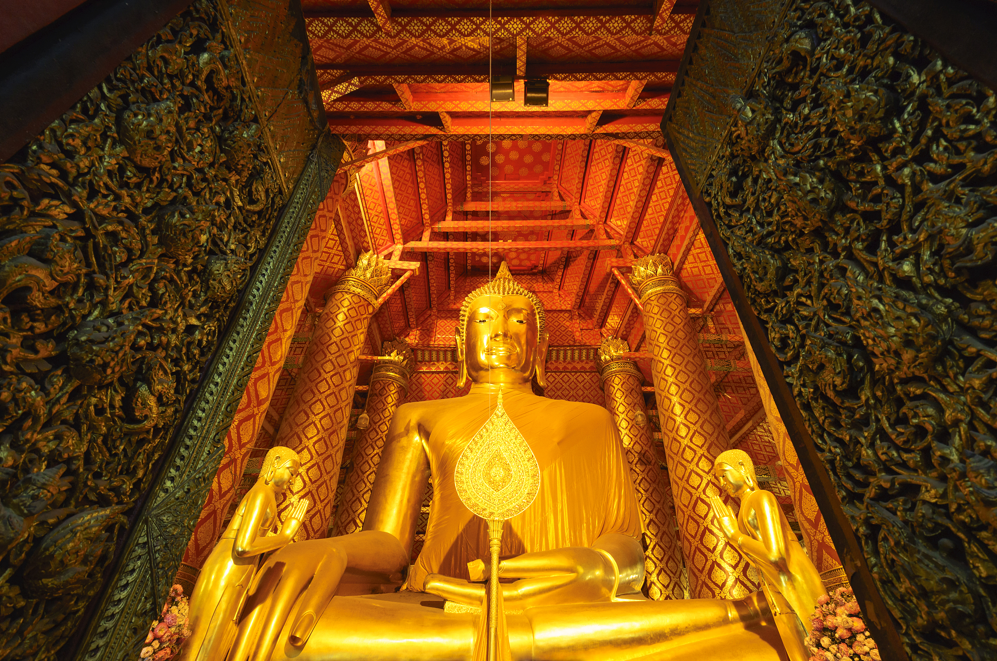 the golden color buddha statue in the church at wat phanan choen