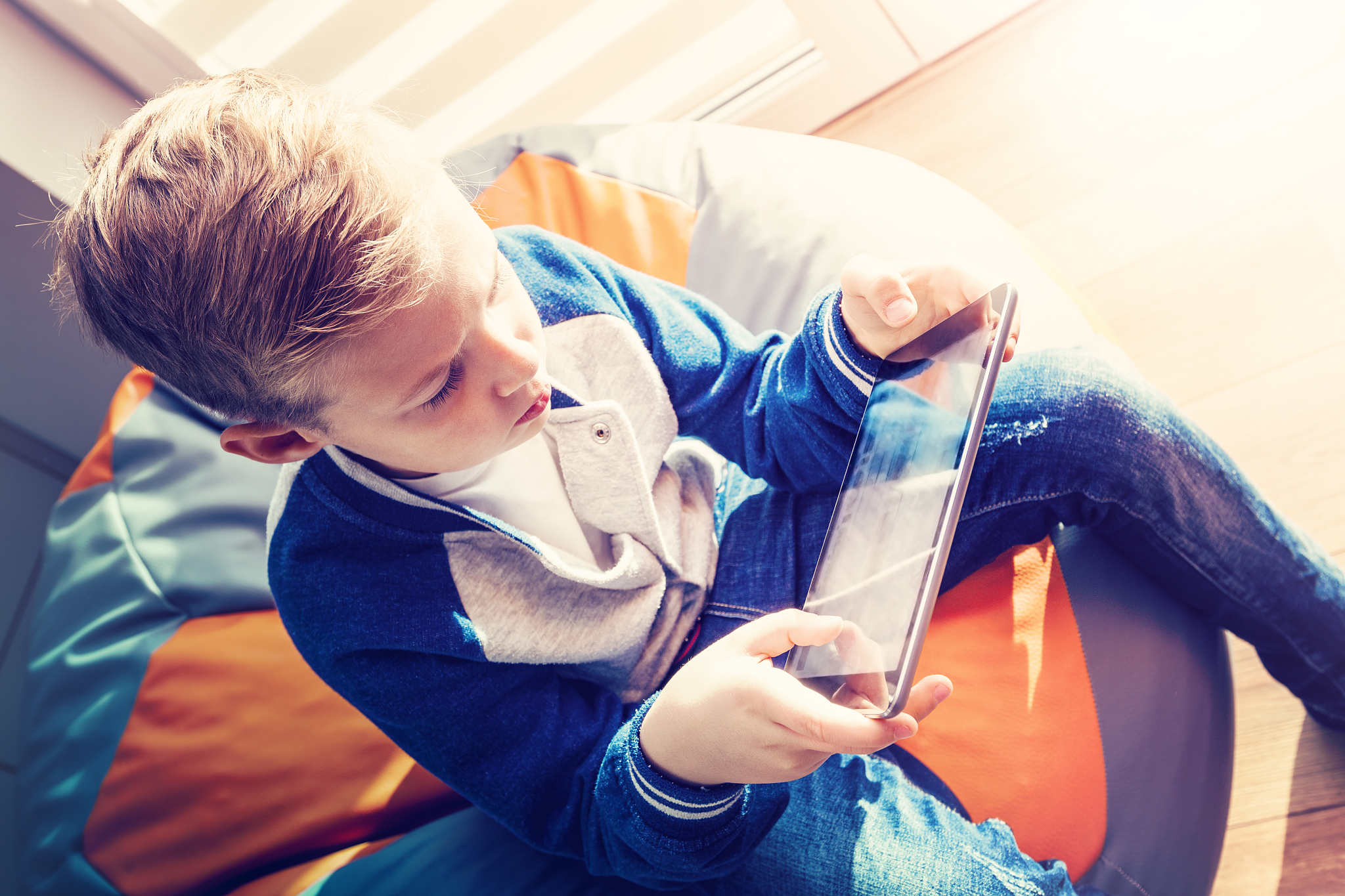 schoolboy with  digital tablet sitting and reads