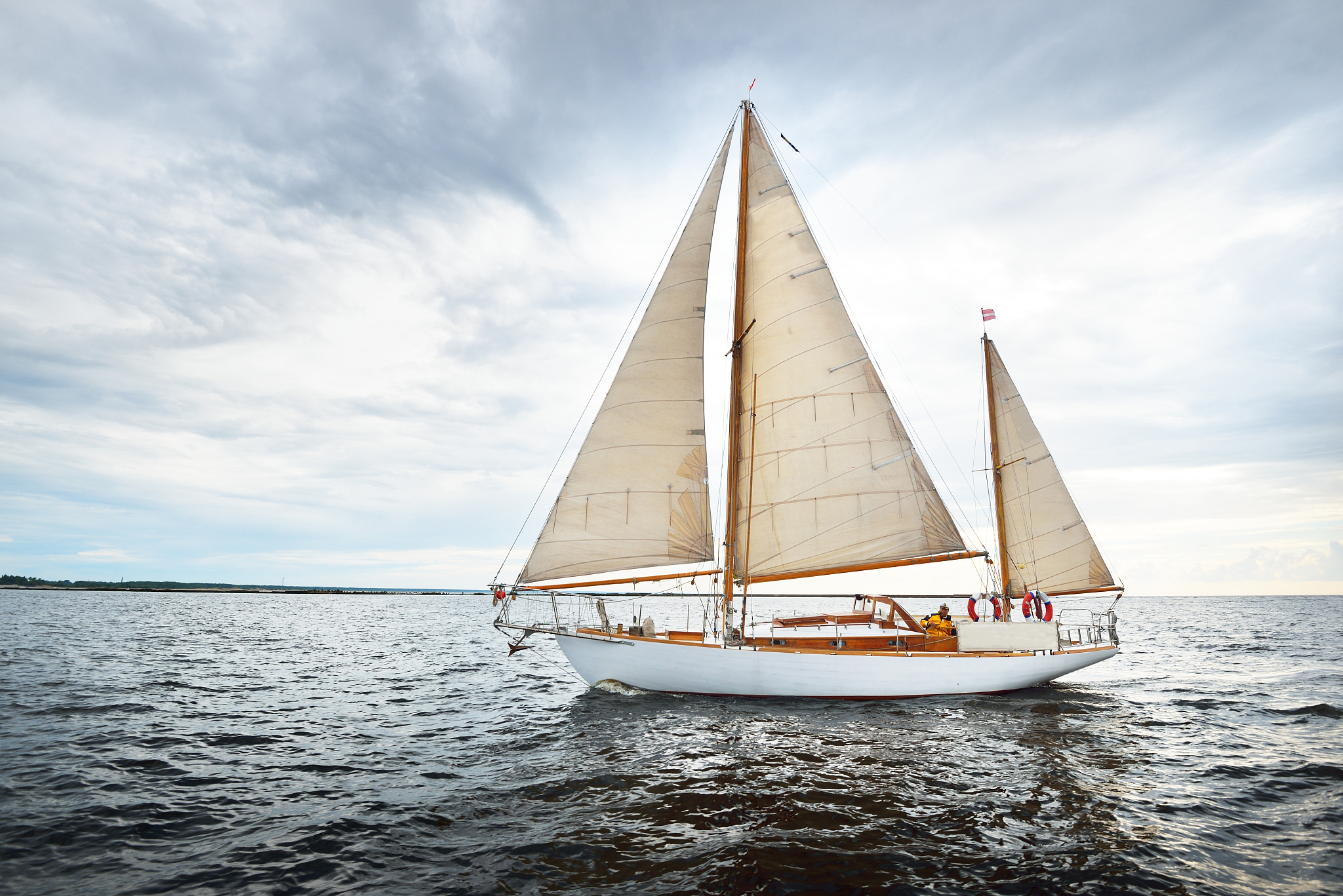 vintage wooden two mast yacht (yawl) sailing in a open sea on a 
