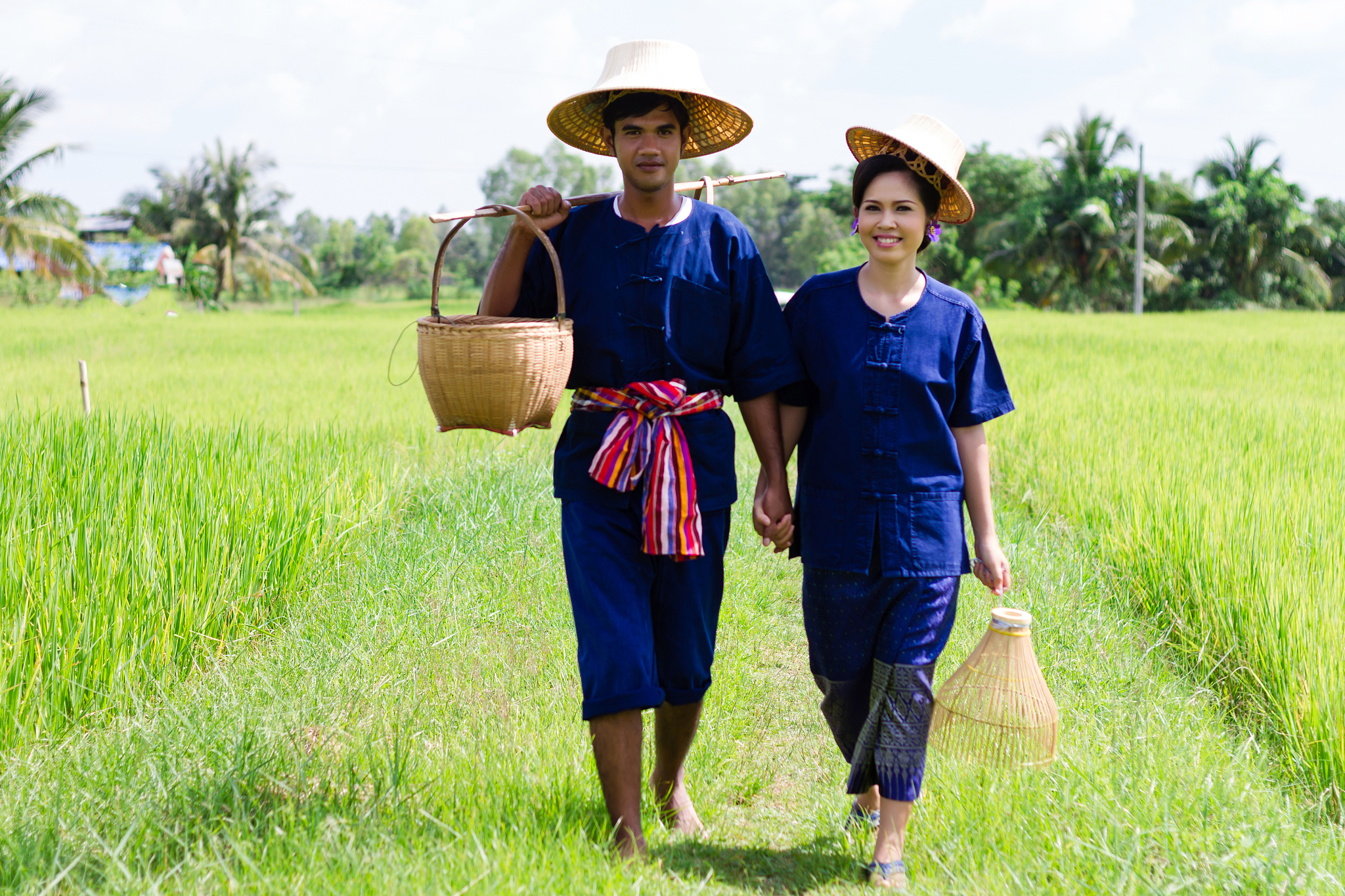 husband and wife thai farmers in the rice field