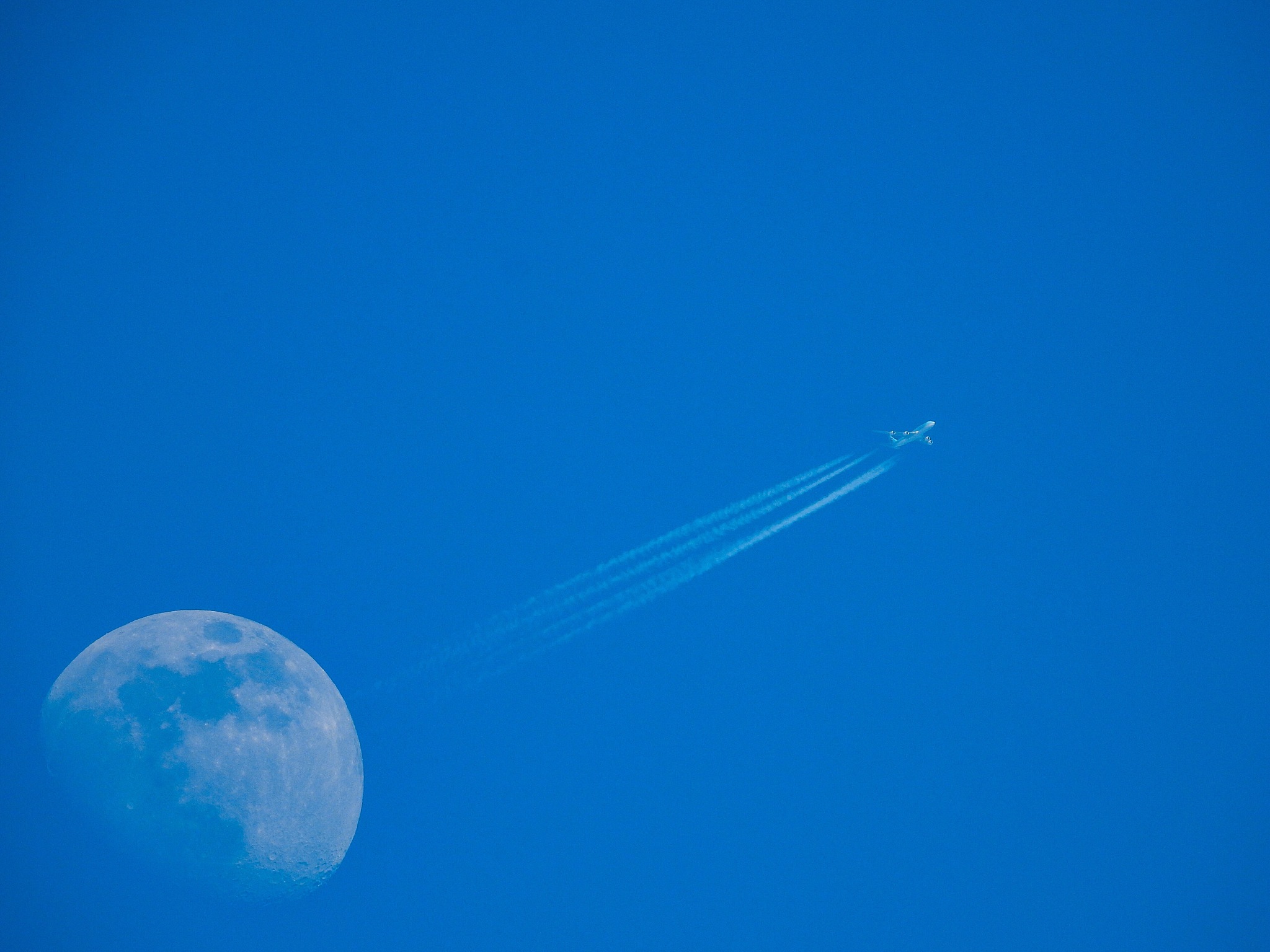 low angle view of vapor trail against clear blue sky