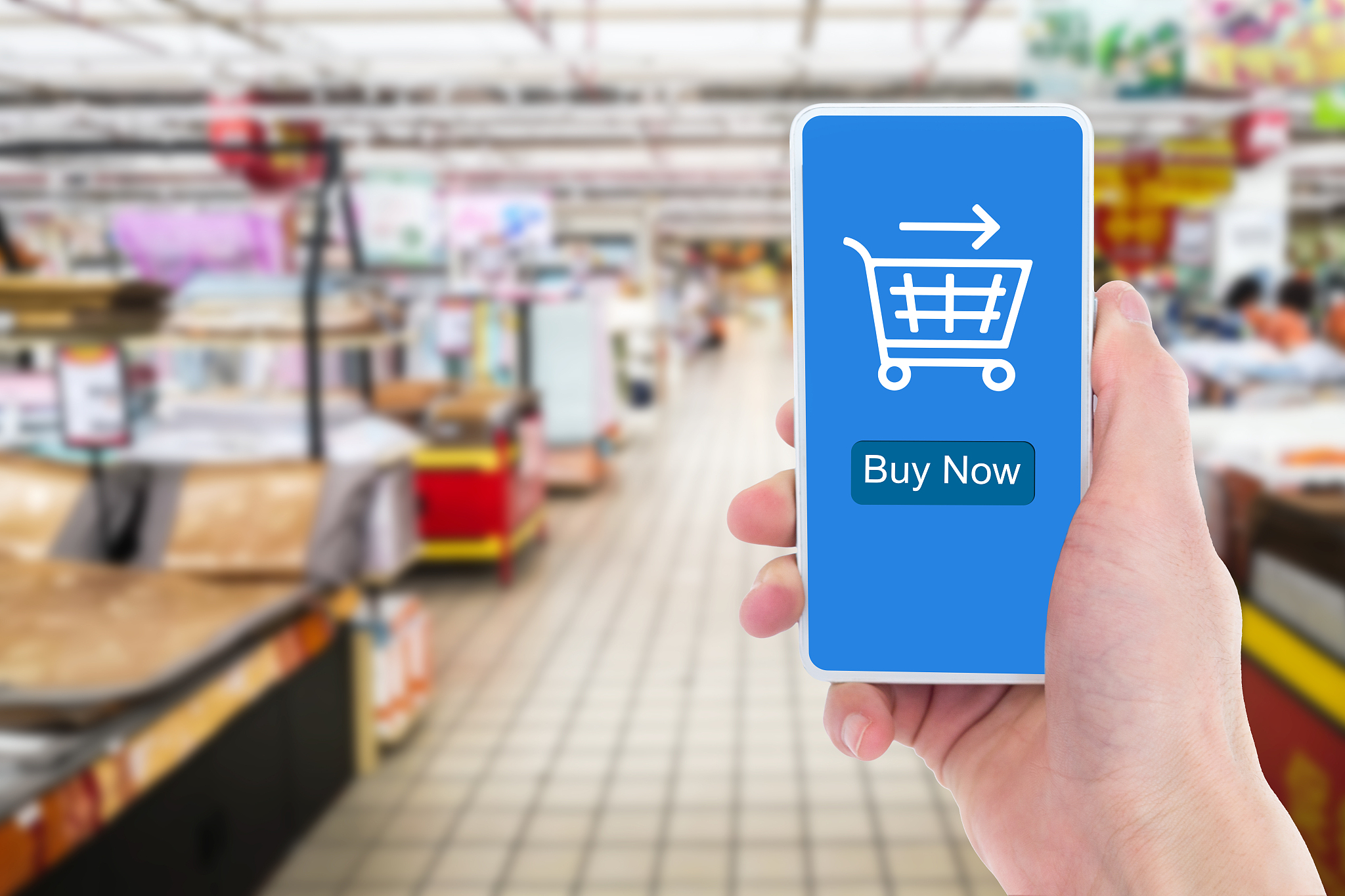 in the supermarket, close-up of a man's hand holding a mobile ph