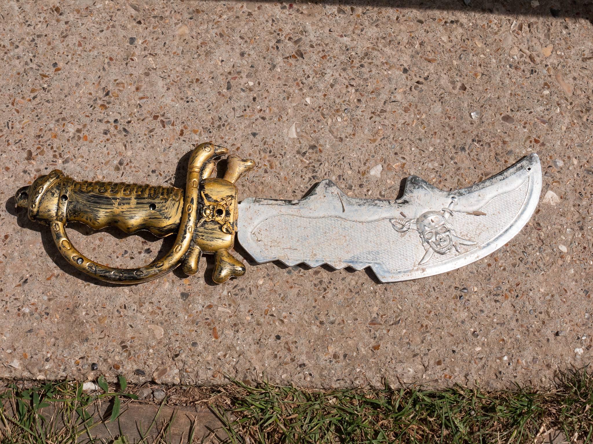 a silver and gold toy pirate sword