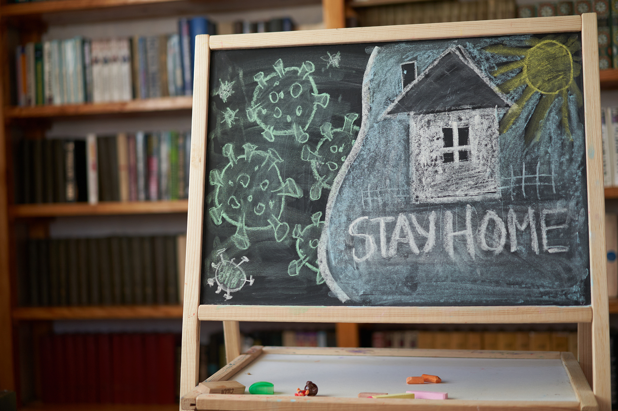 hashtag stay at home. outbreak warning. written white chalk on b