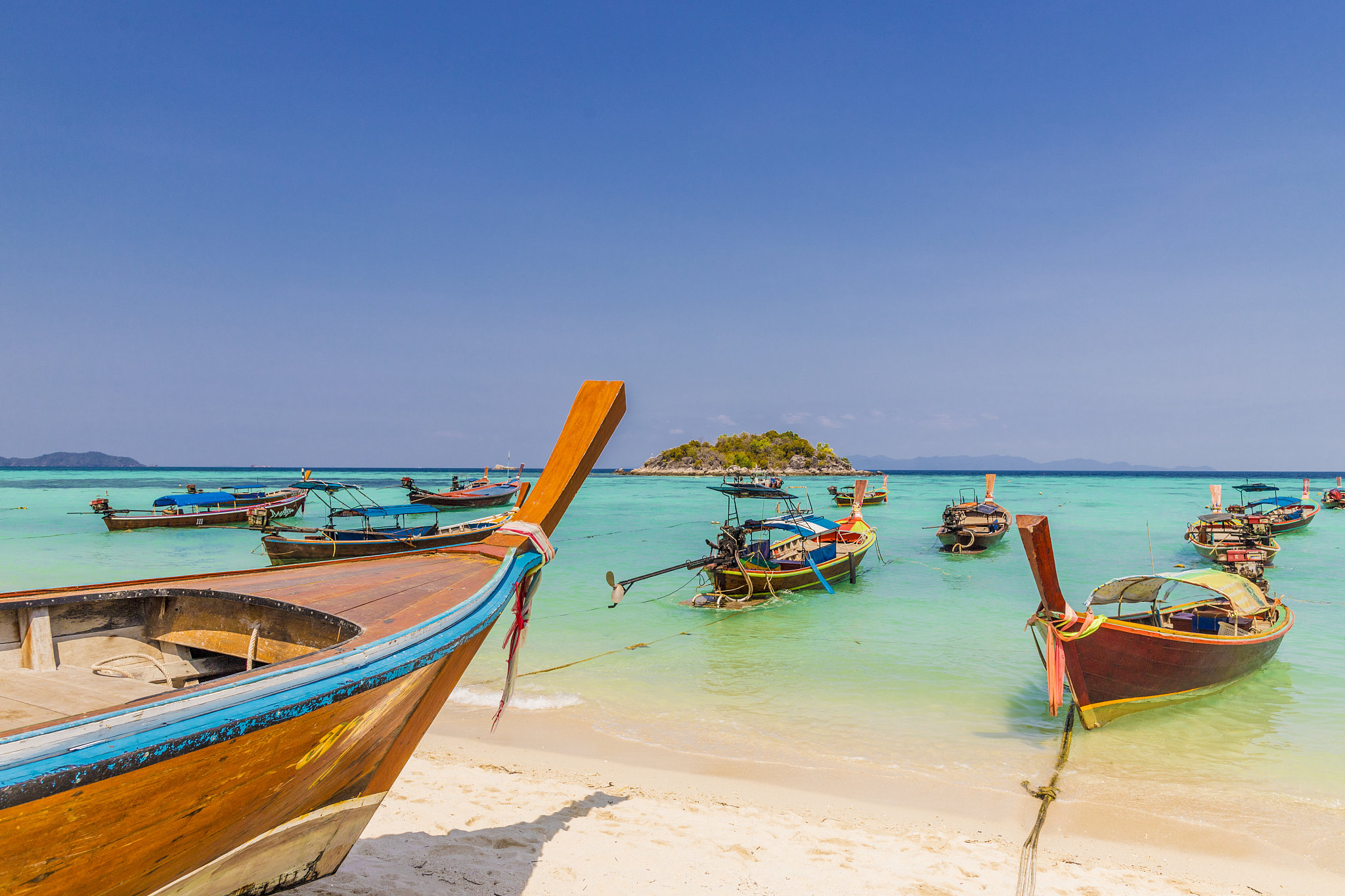 longtail boats on sunrise beach on ko lipe in tarutao national m