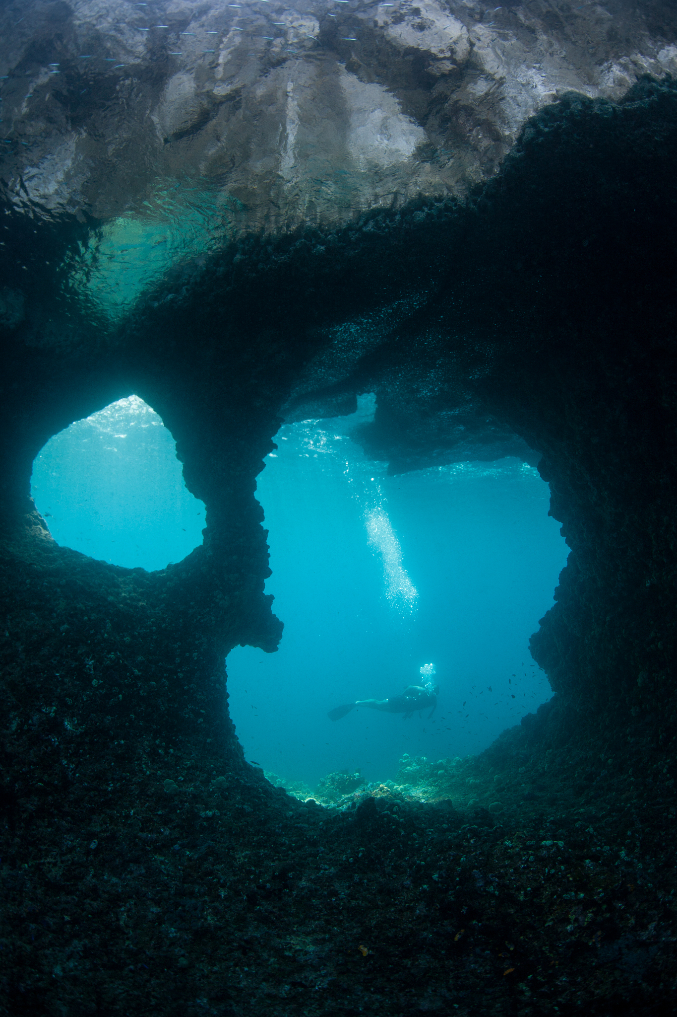 diver and eroded limestone island