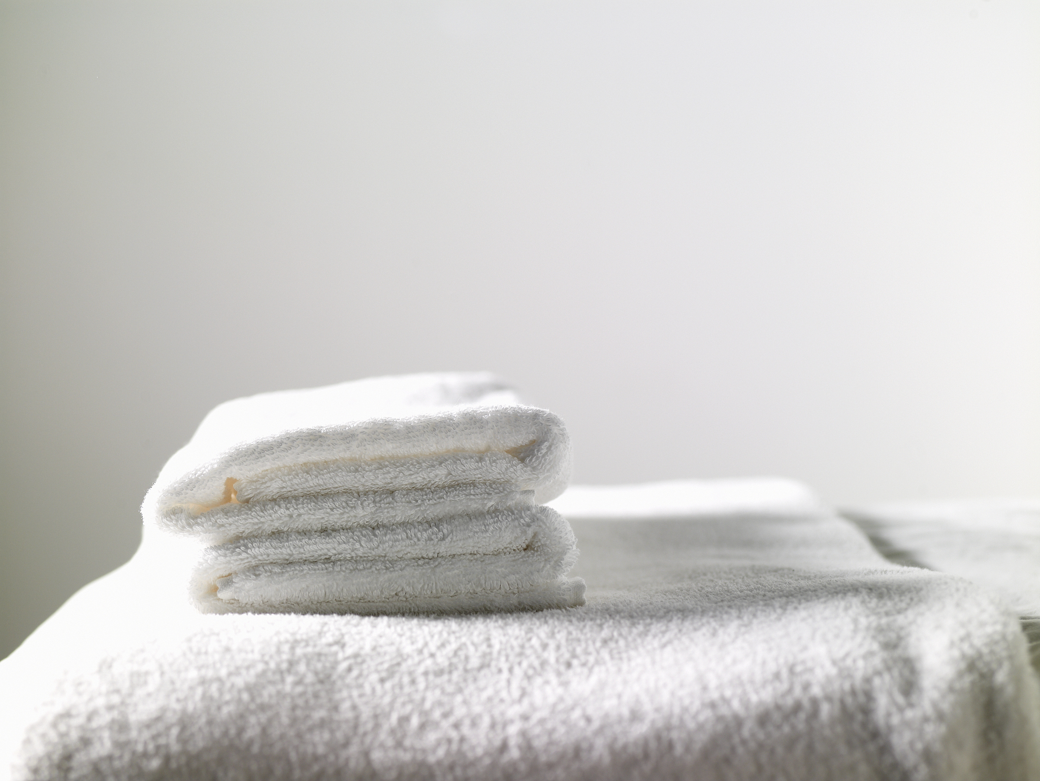 clean white towels on massage table