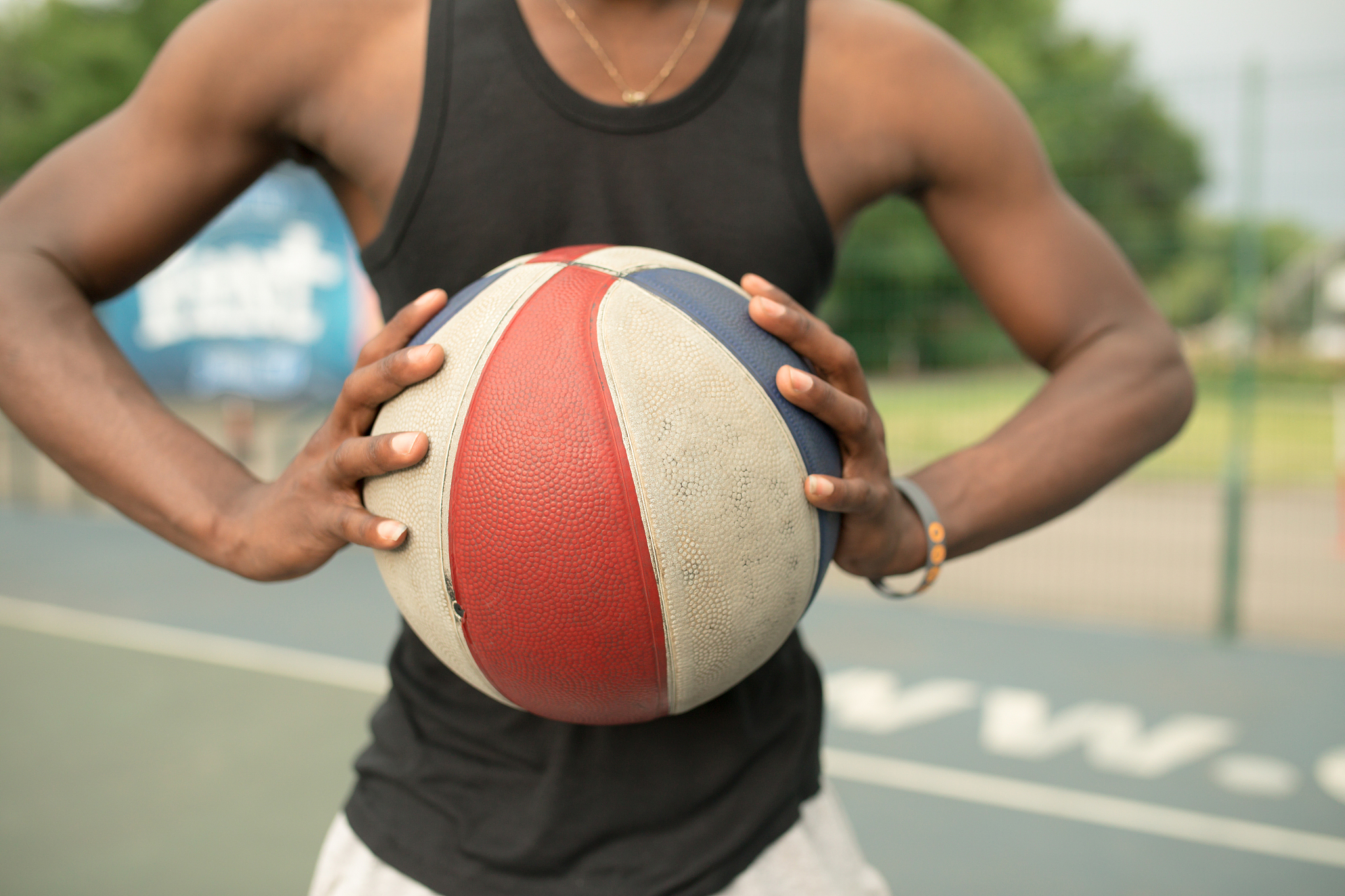 portrait of african american man on basketball court keep ball