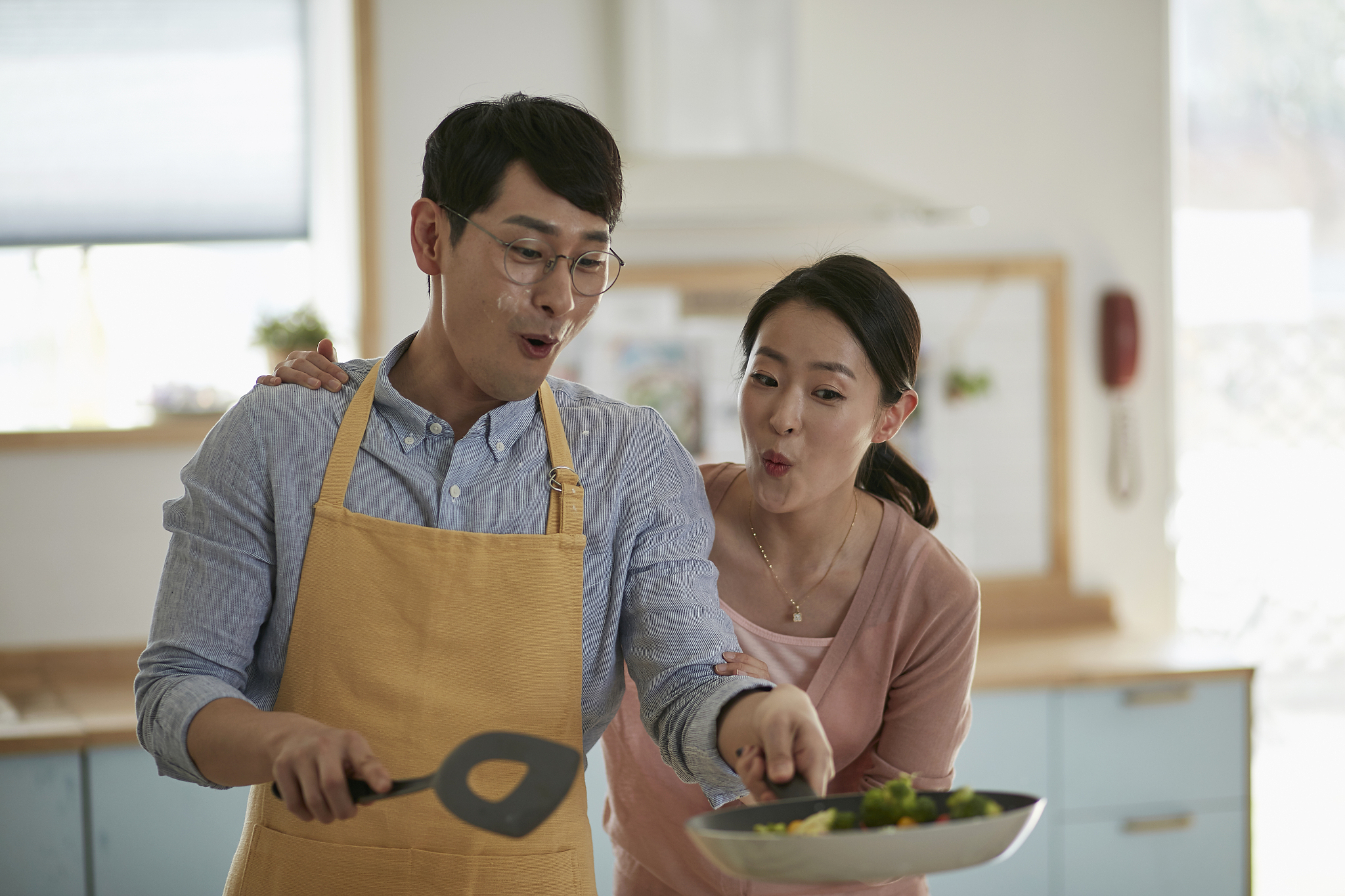 husband and wife cooking together