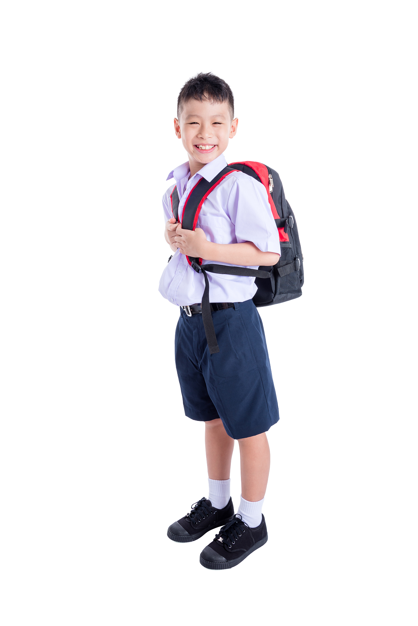 young student in uniform smiling over white