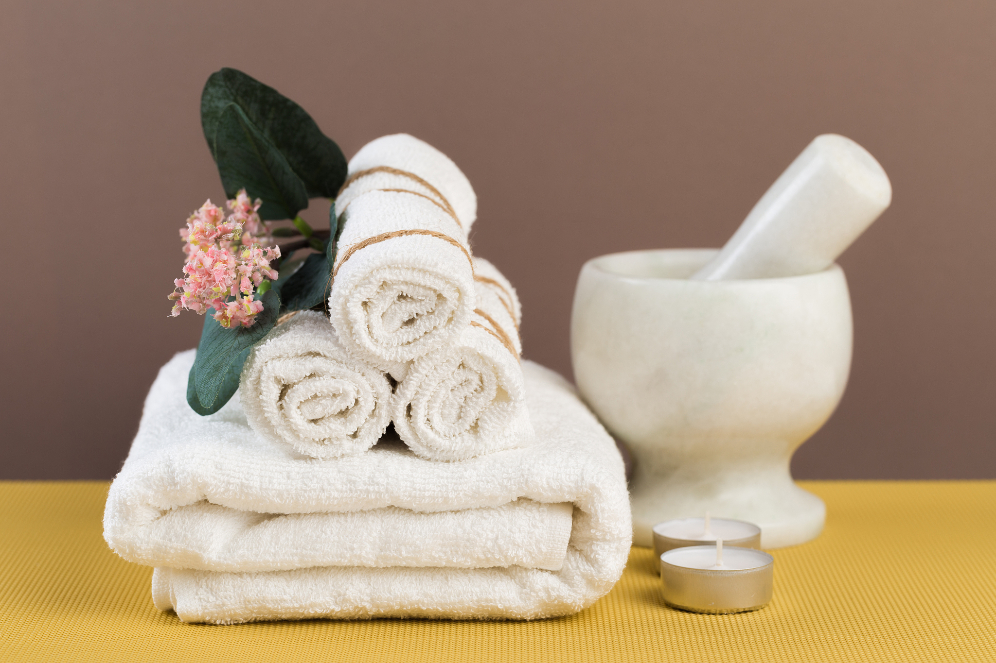 spa still life with aromatic candles, flower and towel. - image