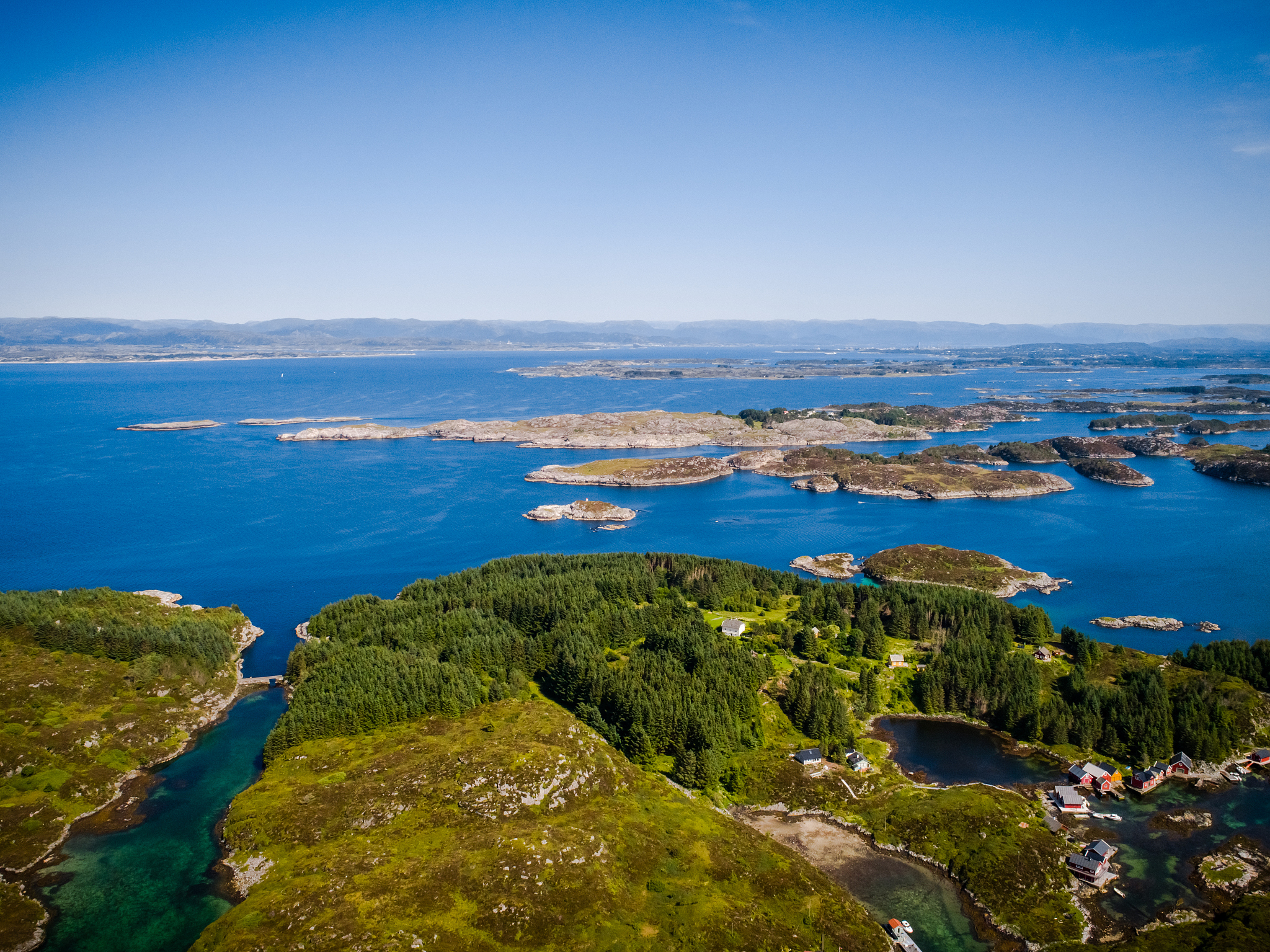 an aerial drone shot of the clear waters of austrheim, norway on