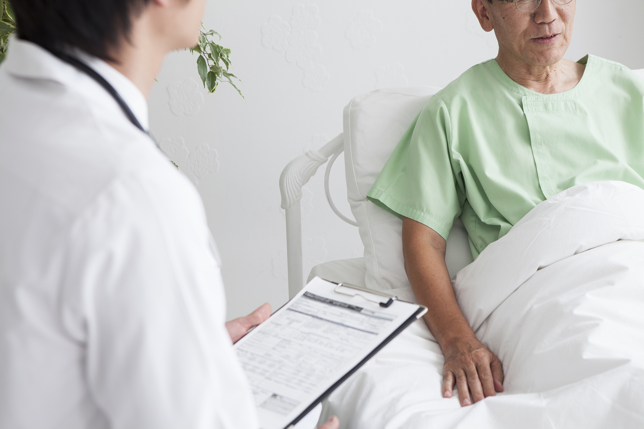 a doctor confirming the condition of an old man in hospital.