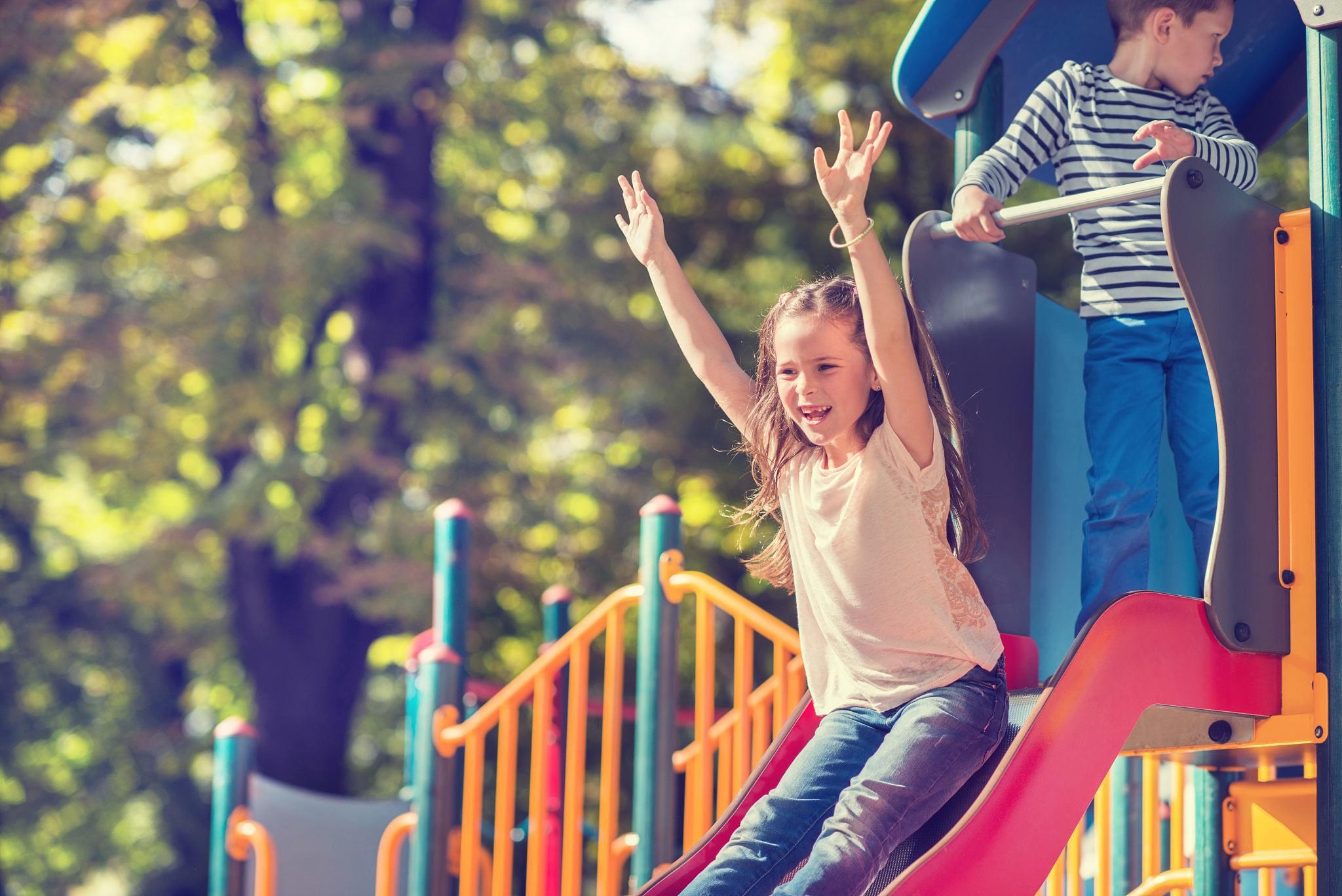 little girl sliding outdoors.