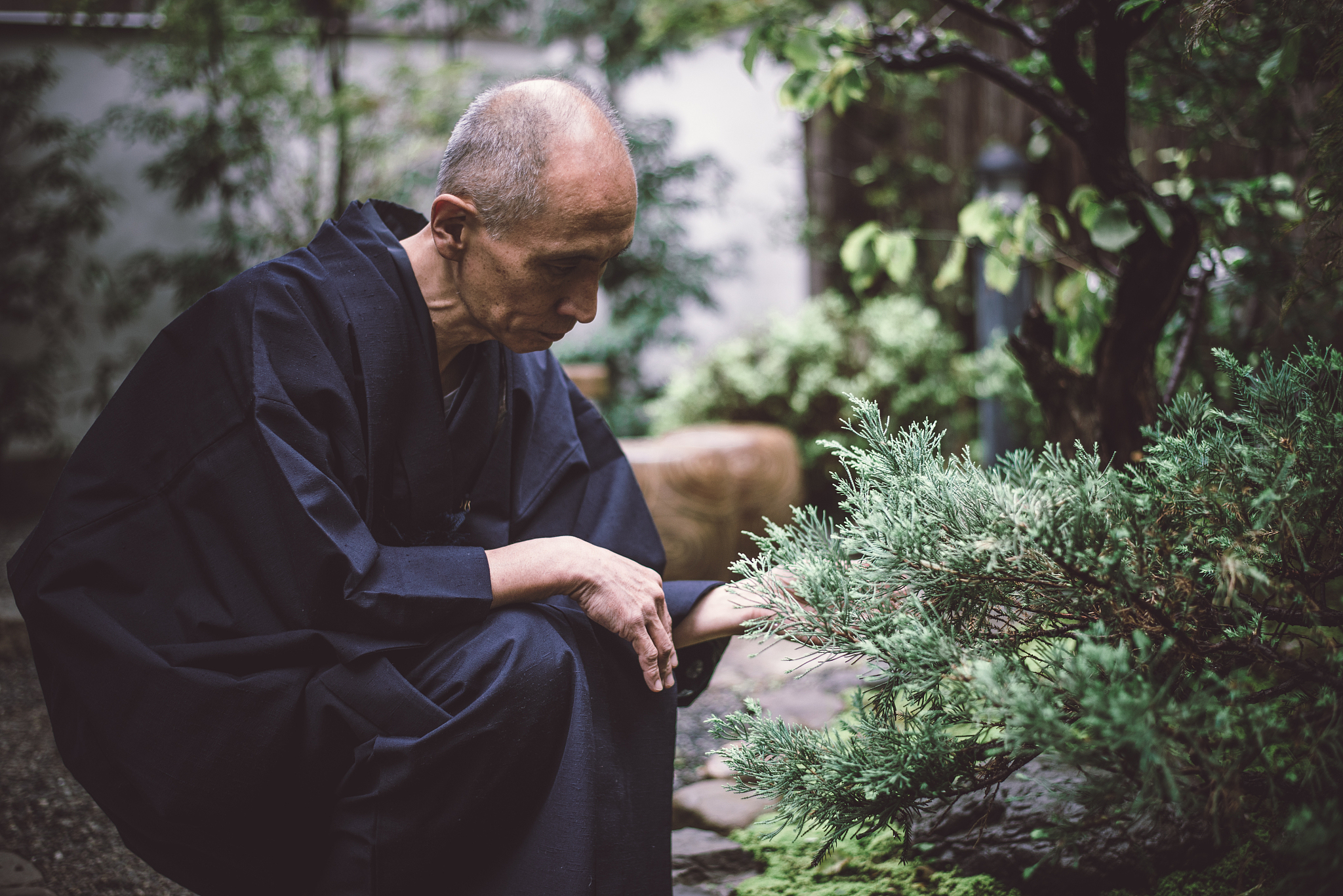 japanese man meditating in his garden