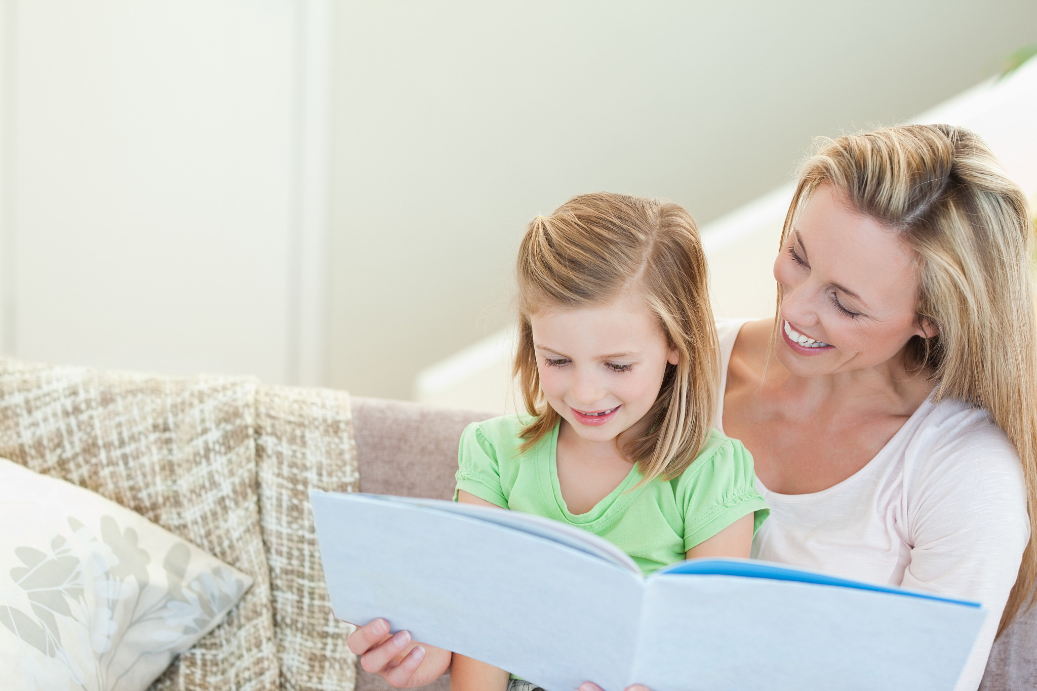 mother and daughter reading a magazine together