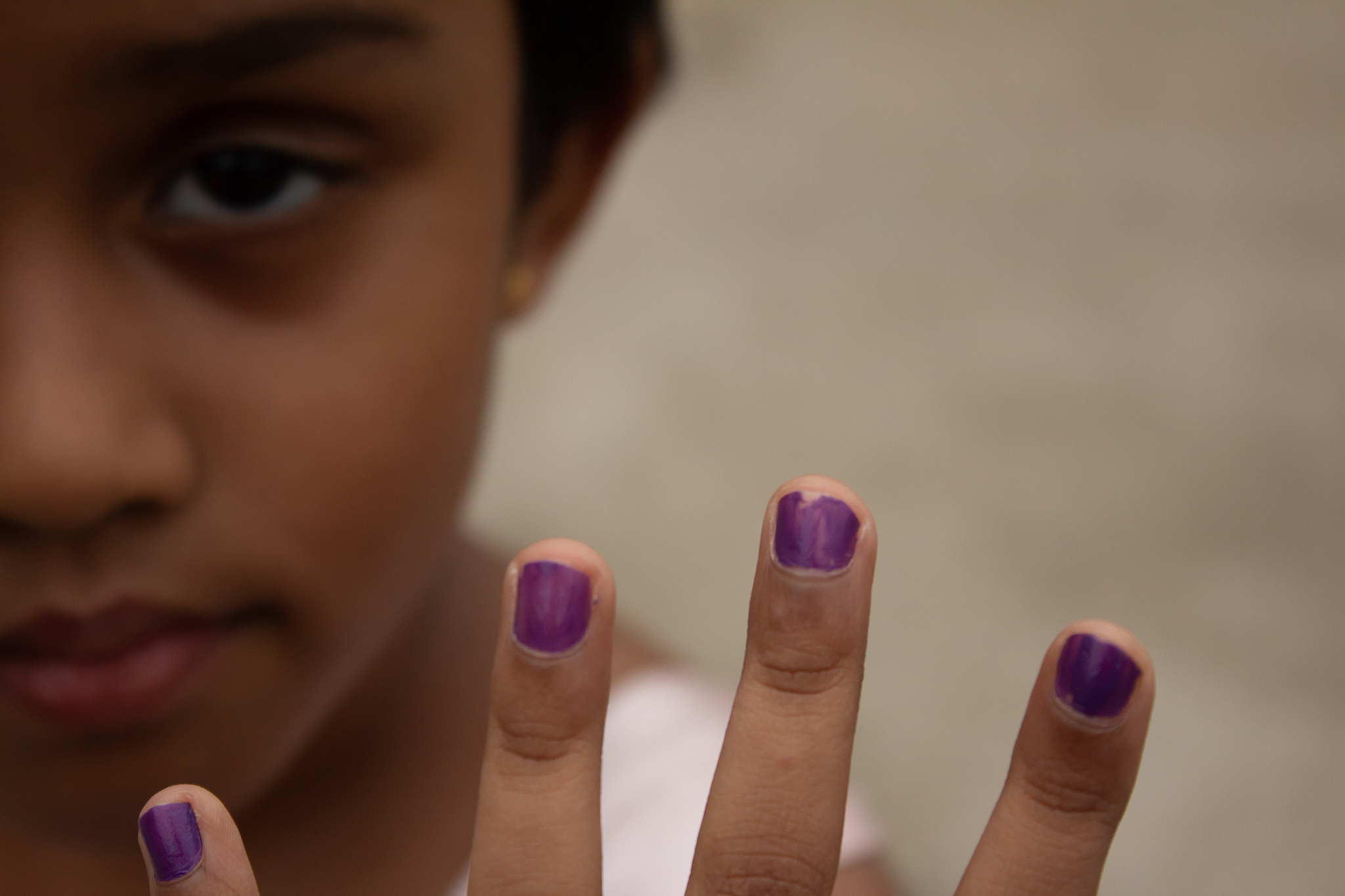 kid showing fingers with nail polish