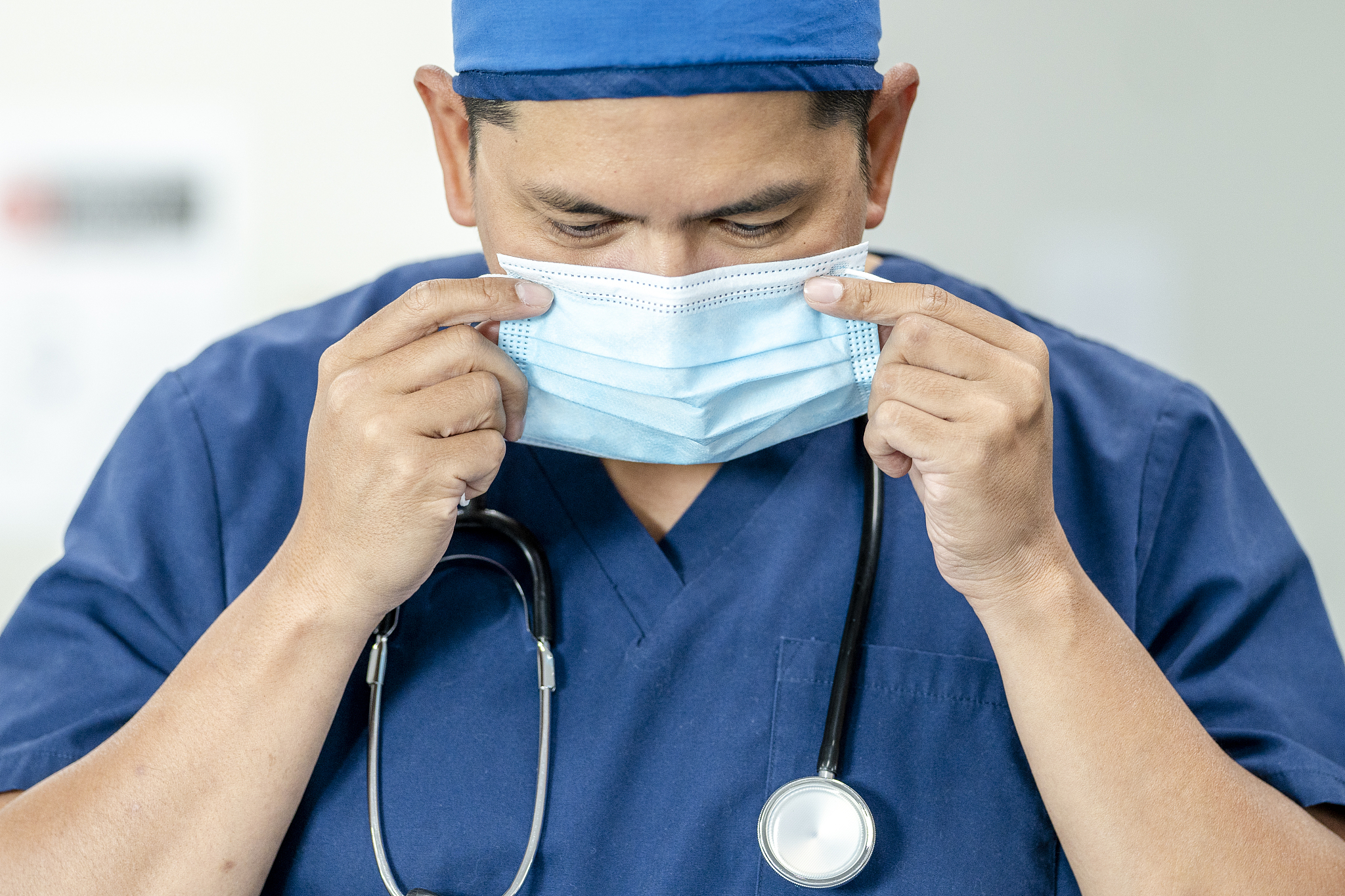 asian male doctor wearing a mask