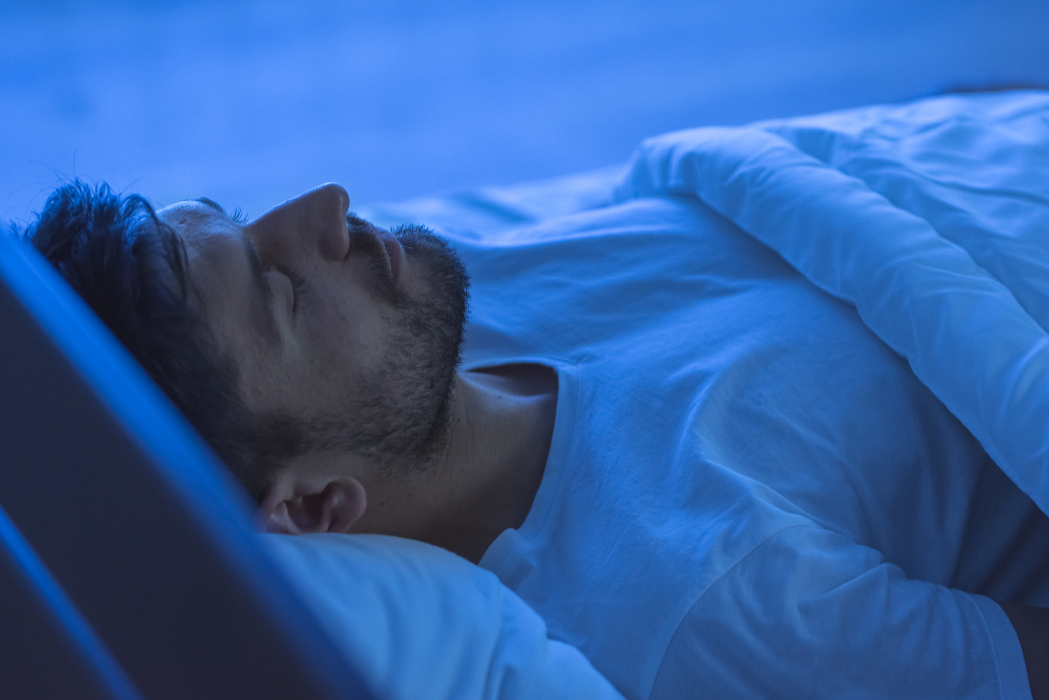 the man sleeping in the bed. night time