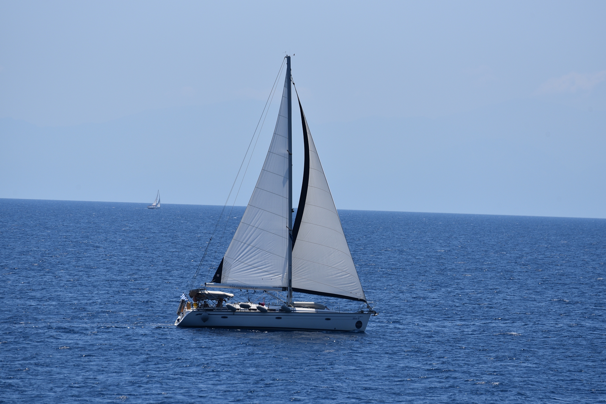 sailboat sailing on sea against clear sky