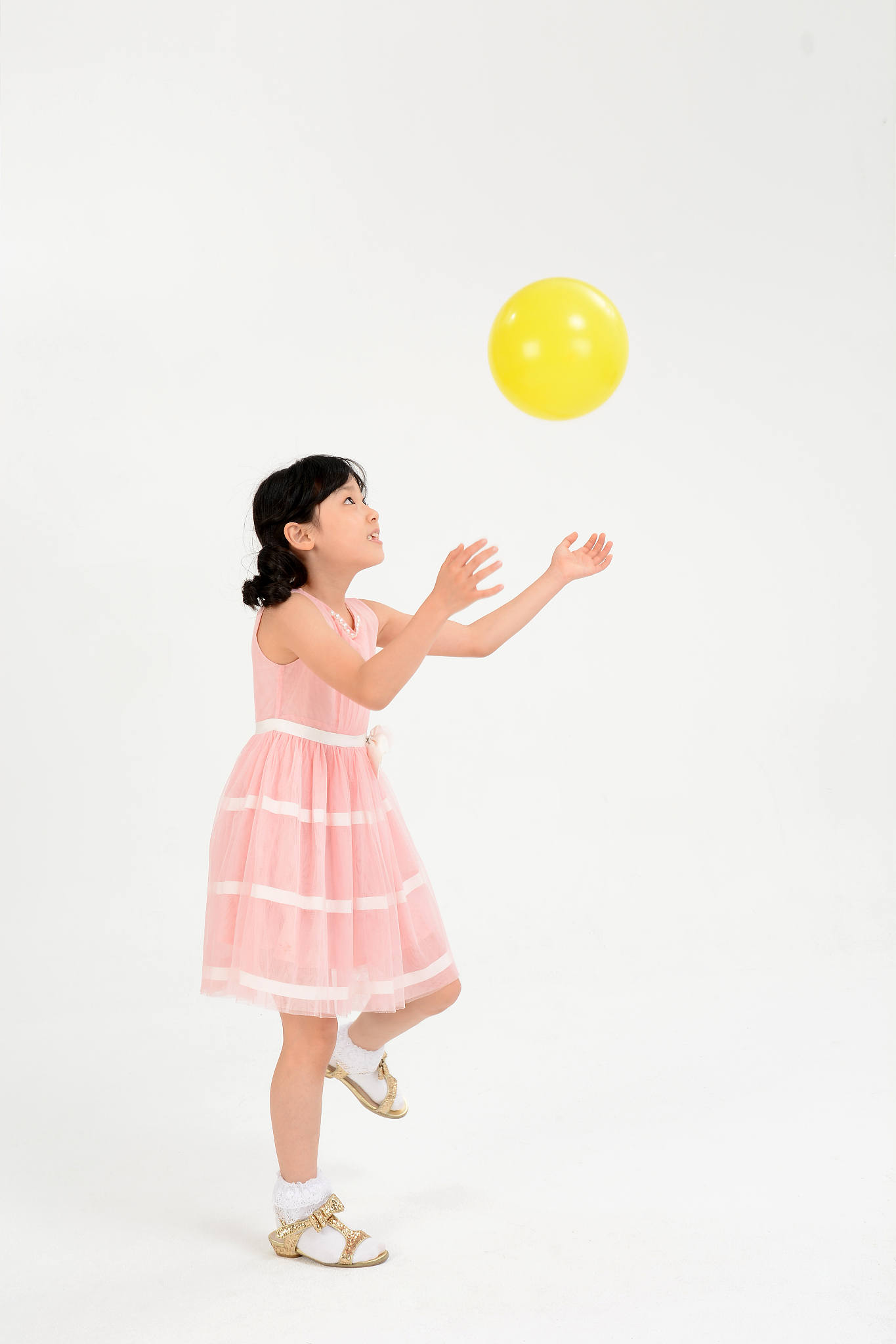 girl playing with balloons