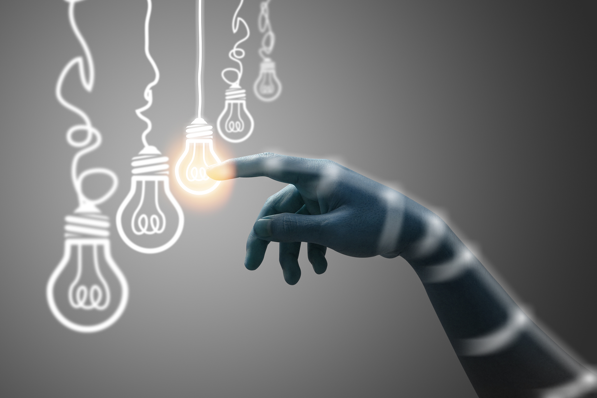 idea concept. hand touch on light bulb on gray background