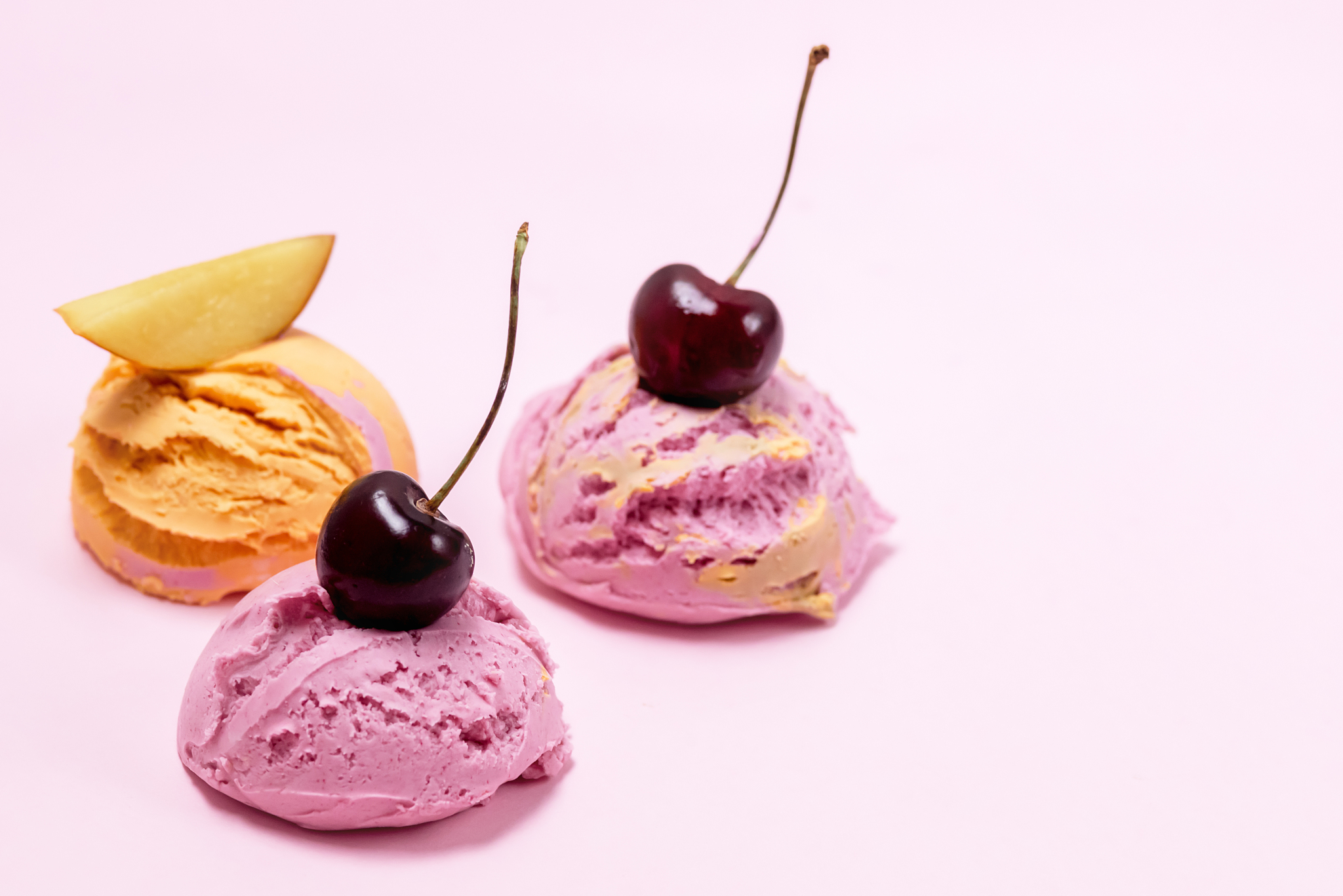 set of three various ice cream balls or scoops decorated with fr