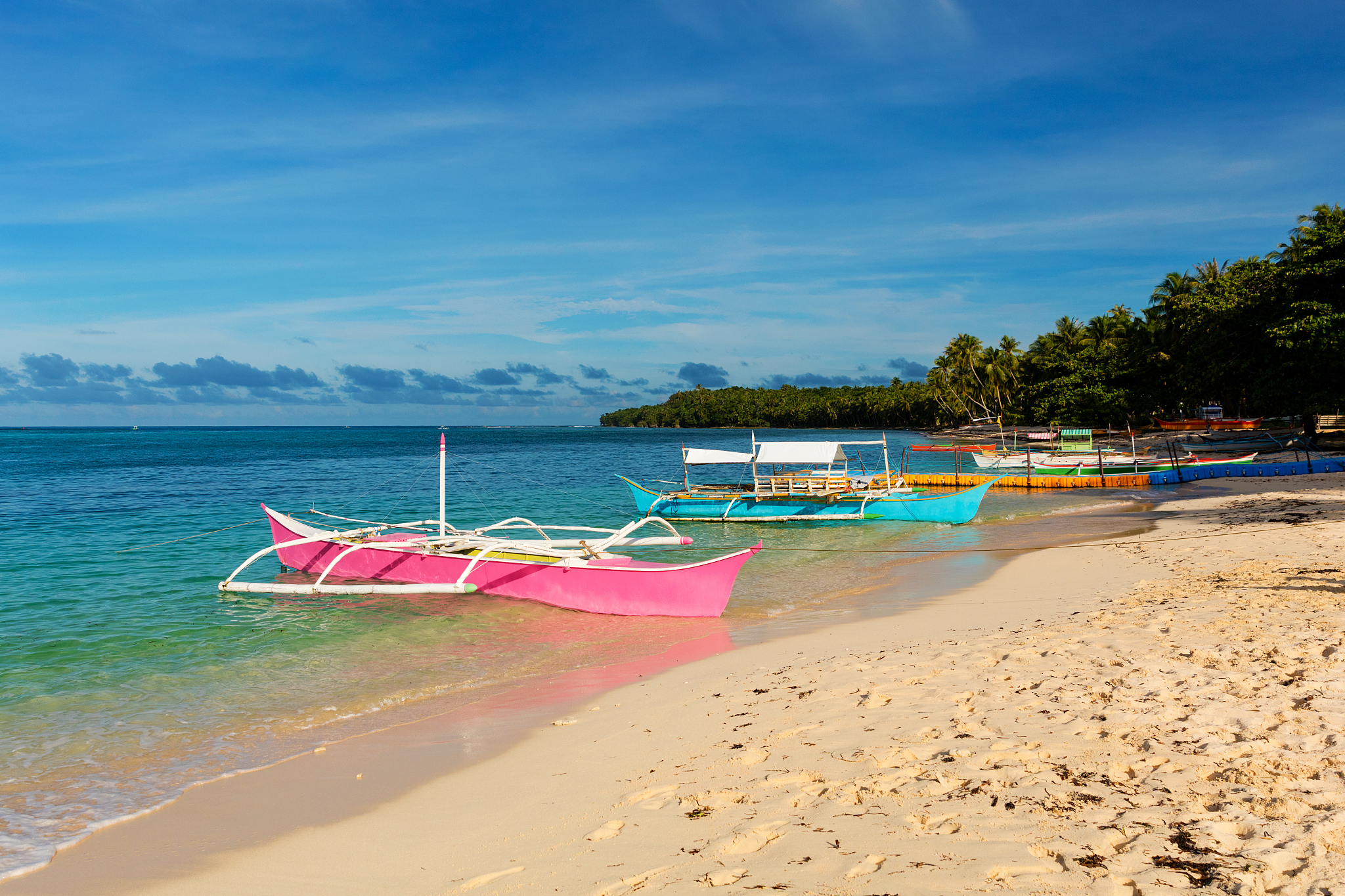 traditional fishing boats on pristine beach, philippines