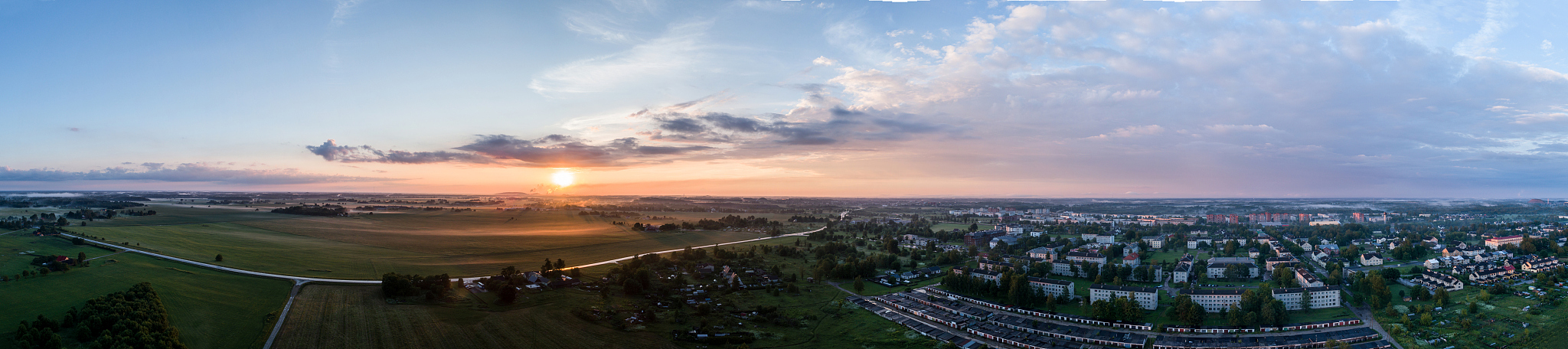 aerial view of city in fog at amazing sunset. panorama.