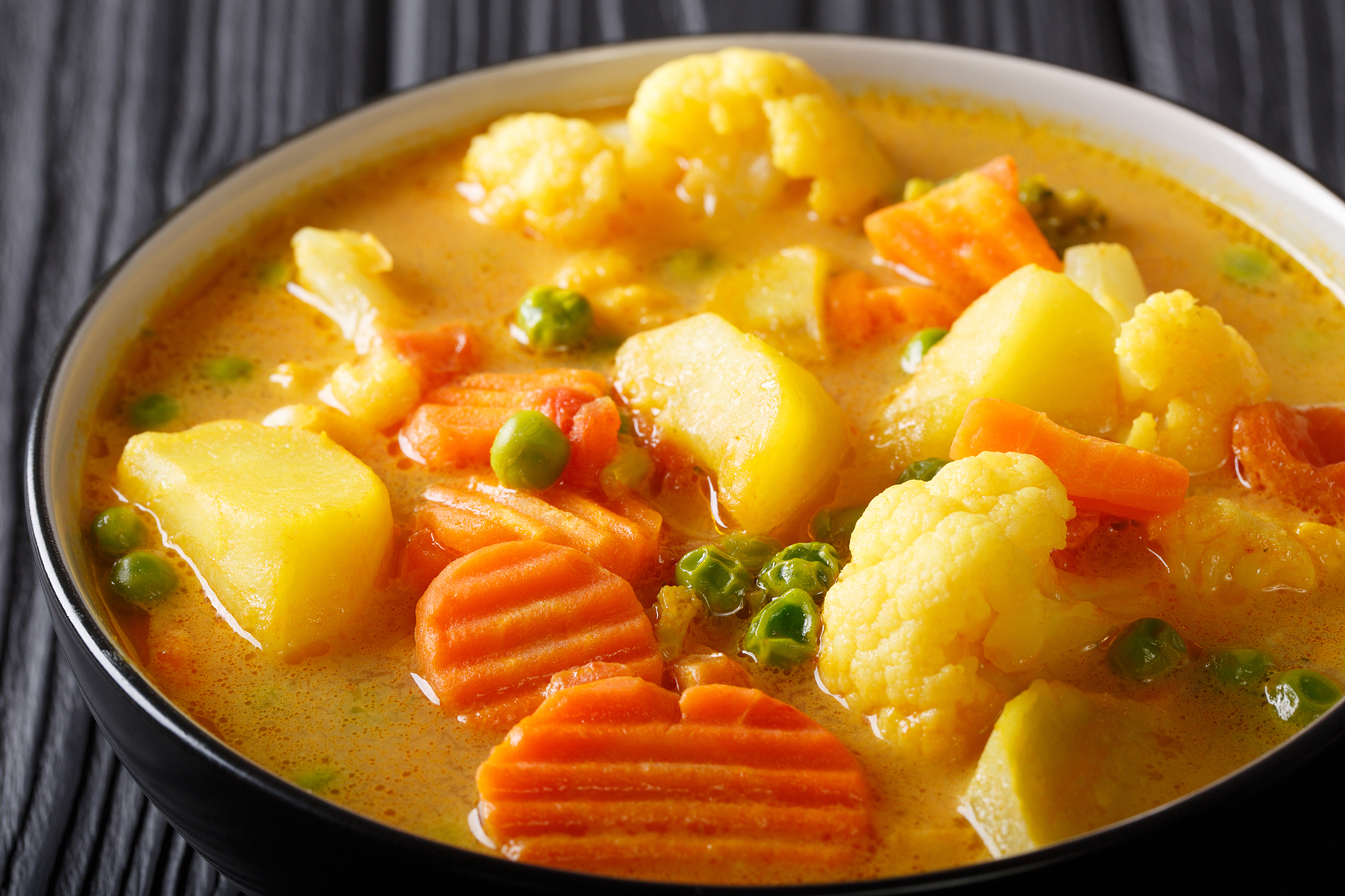 vegetarian vegetable curry with coconut milk close-up in a bowl.