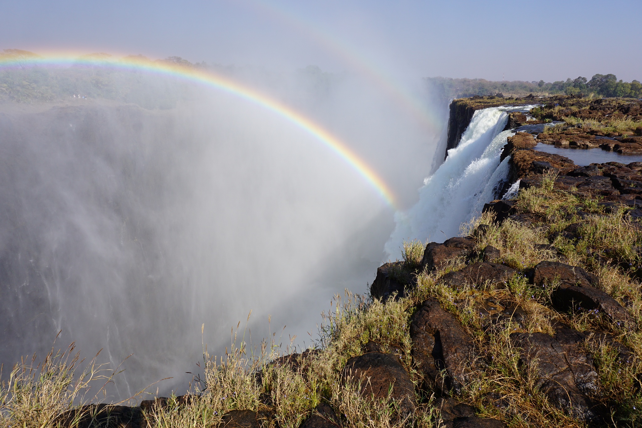 scenic view of rainbow over mountain against sky,victoria falls,