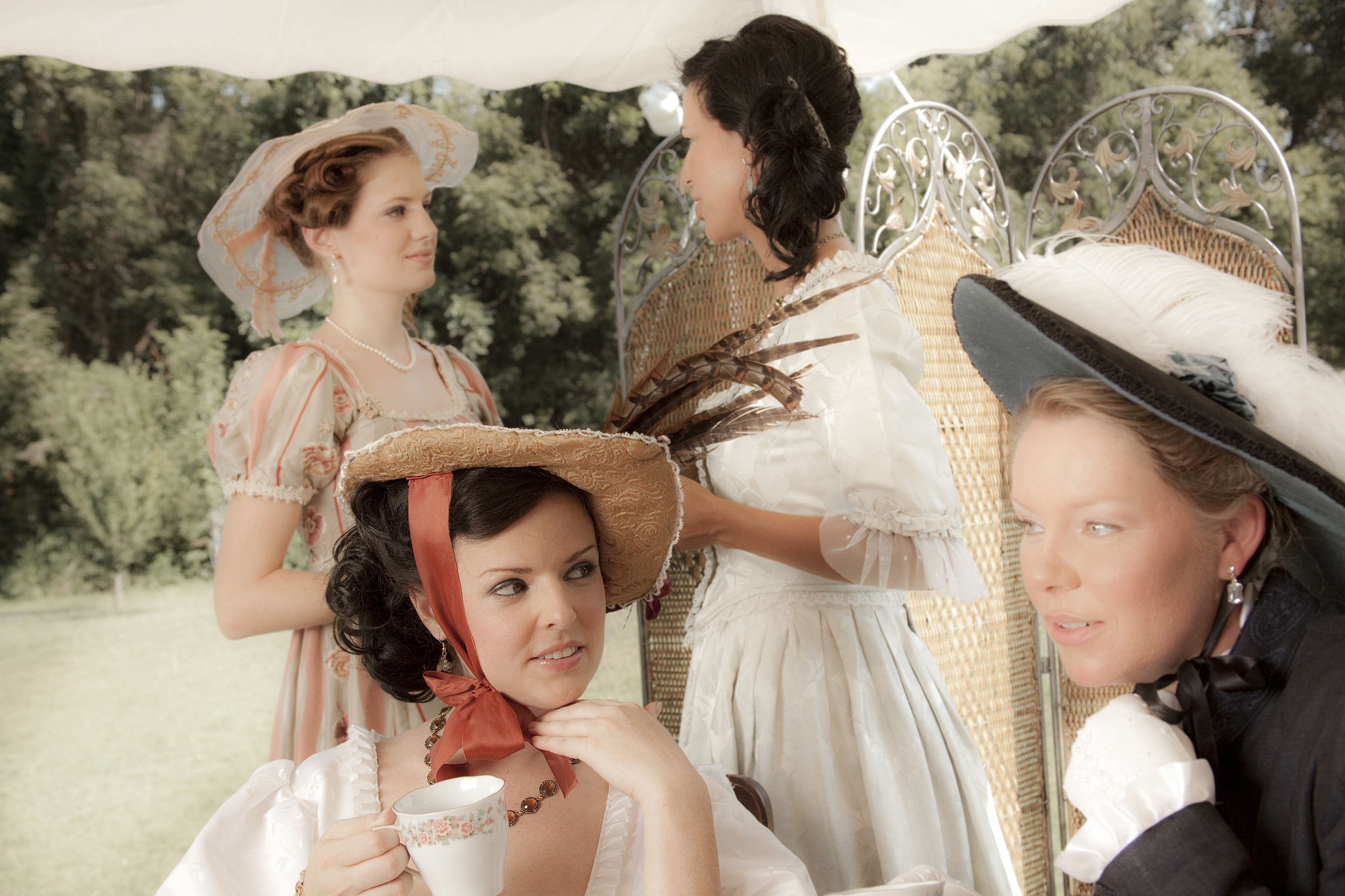 fashion: victorian style women have afternoon tea.