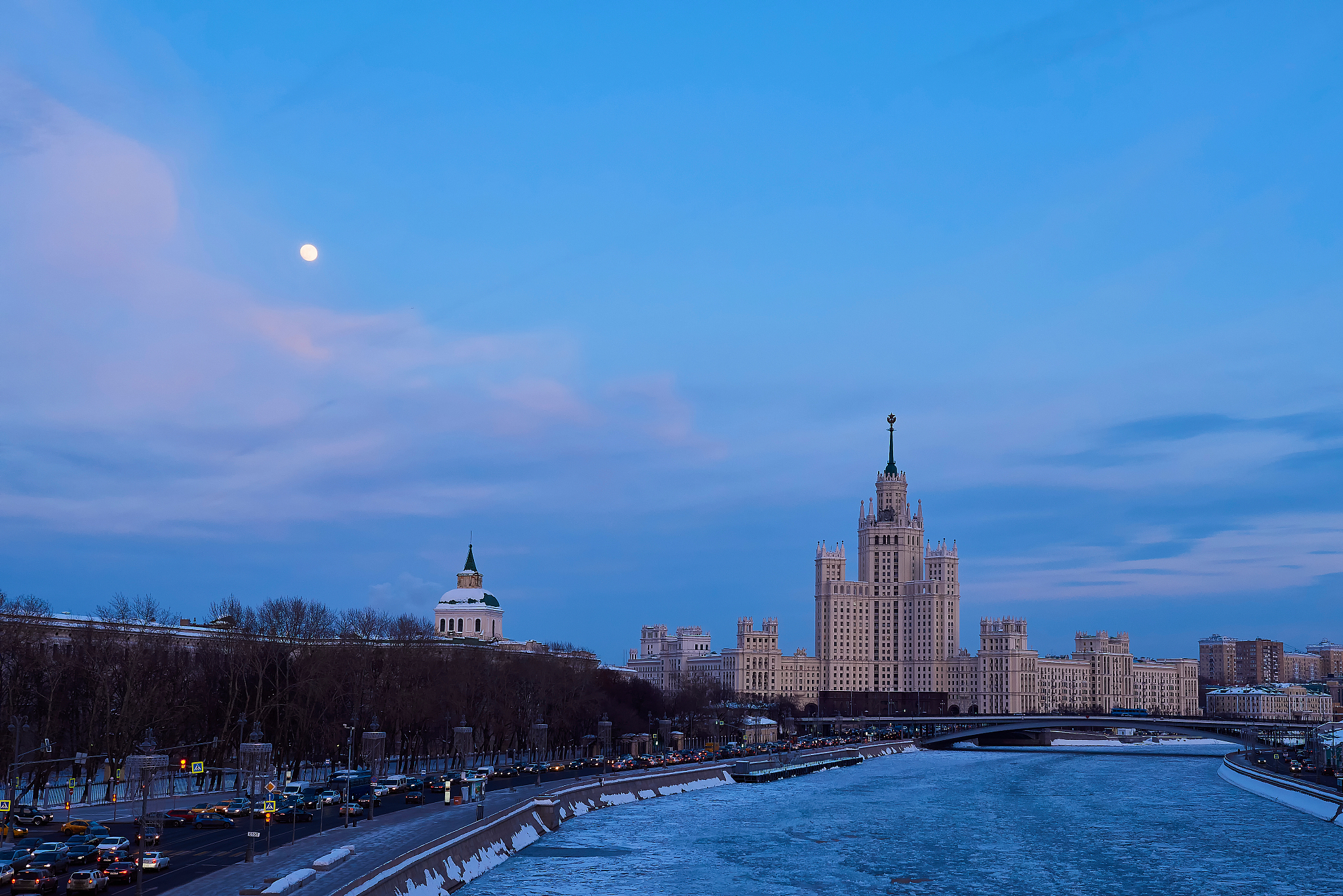 buildings in city against cloudy sky