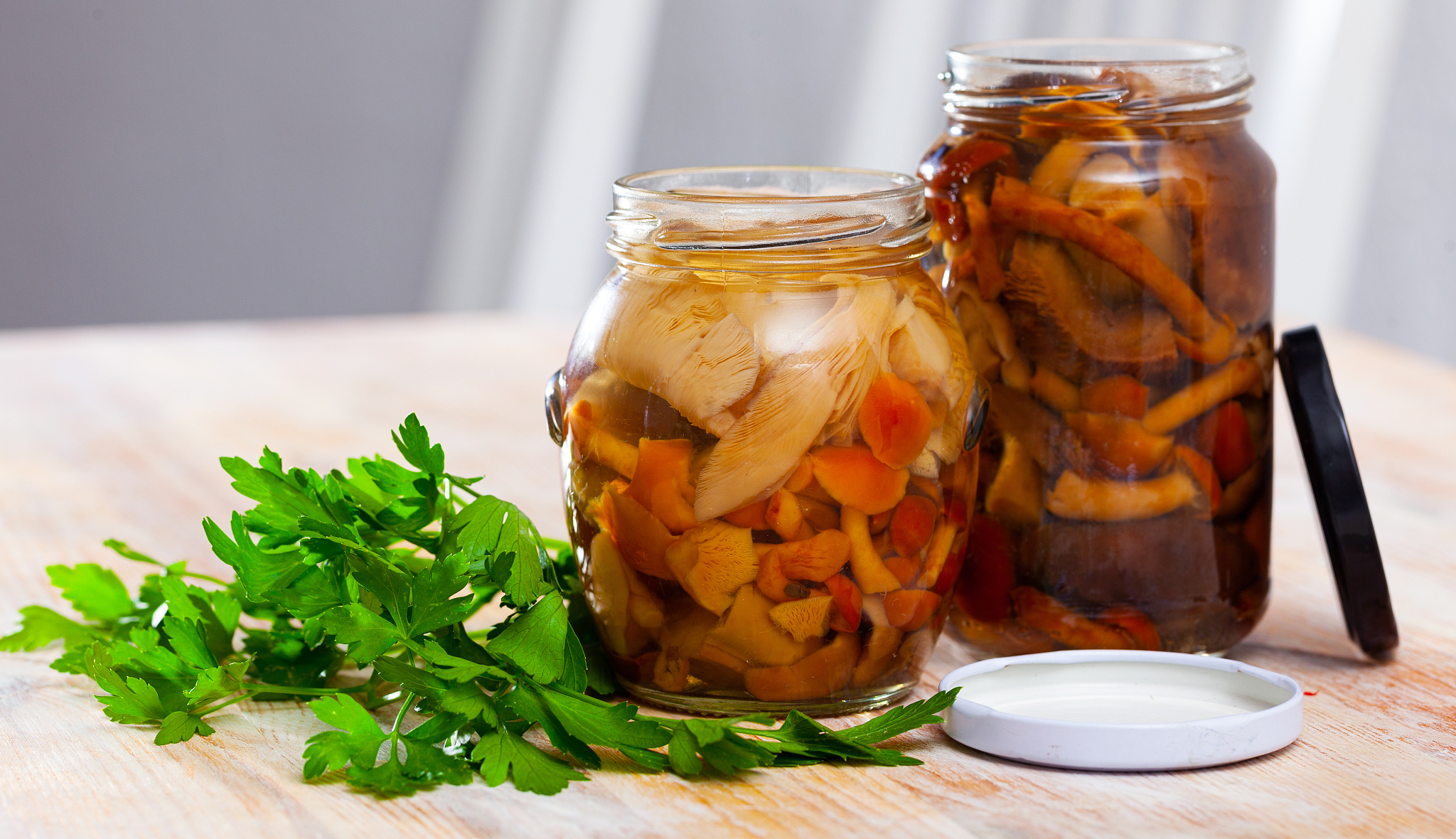assorted marinated mushrooms in glass jar